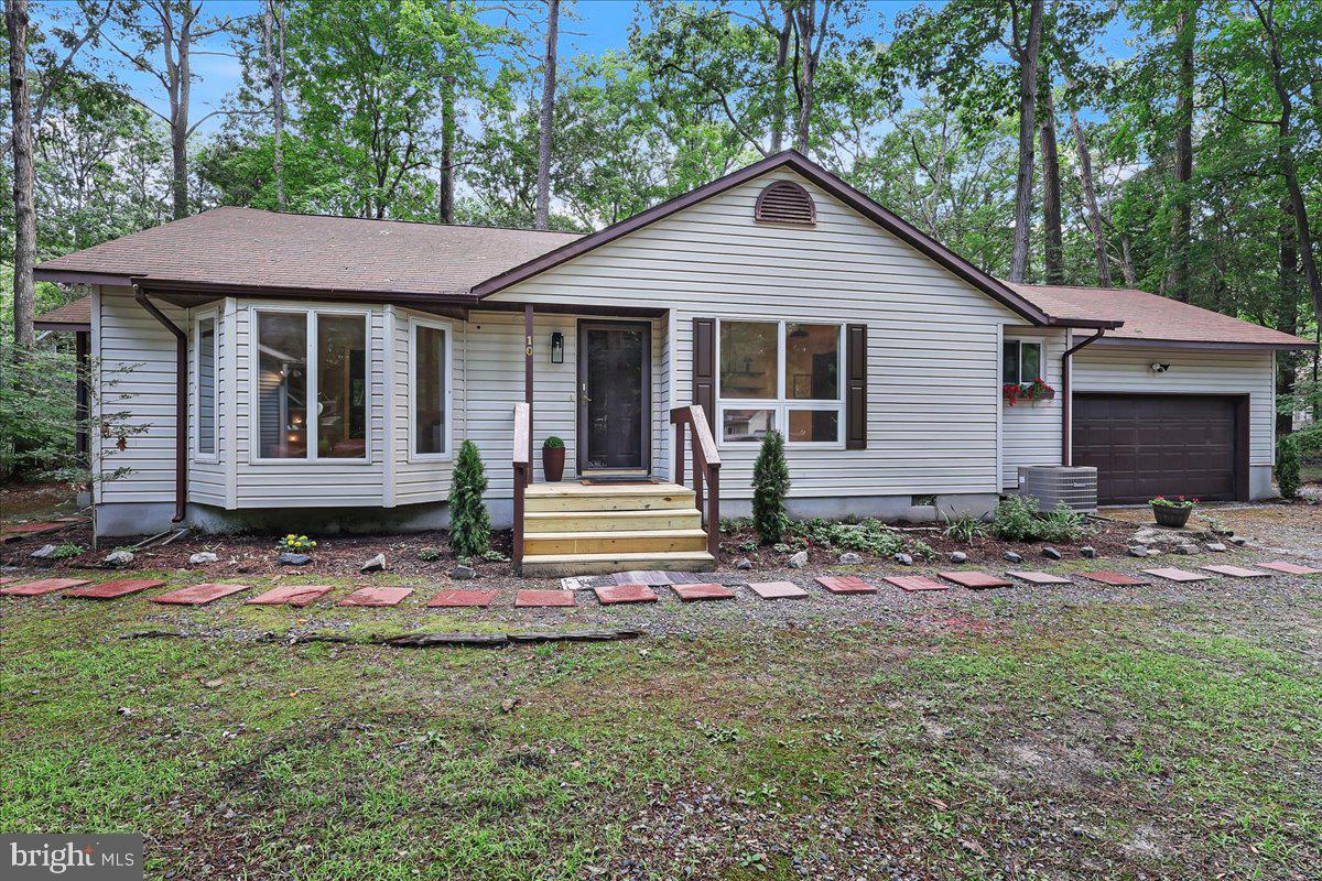 This 3-bedroom, 2-bath home on a quiet cul-de-sac offers an oversized lot, a 2-car garage, and easy outdoor living with a screened porch and deck. Inside, you'll find new LVP flooring throughout, fresh paint, updated light fixtures, and solid surface countertops in the kitchen and primary bath. The hall bath features a new vanity, and the kitchen includes a brand-new range. The hot water heater is approximately two years old. Ample storage includes a coat closet, linen closet, and attic with pull-down stairs. Located in the sought-after Ocean Pines community, residents enjoy exceptional amenities including golf, marinas, parks, pools, pickleball and tennis courts, a yacht club, beach club, farmers market, and miles of walking trails—all just minutes from Ocean City beaches.