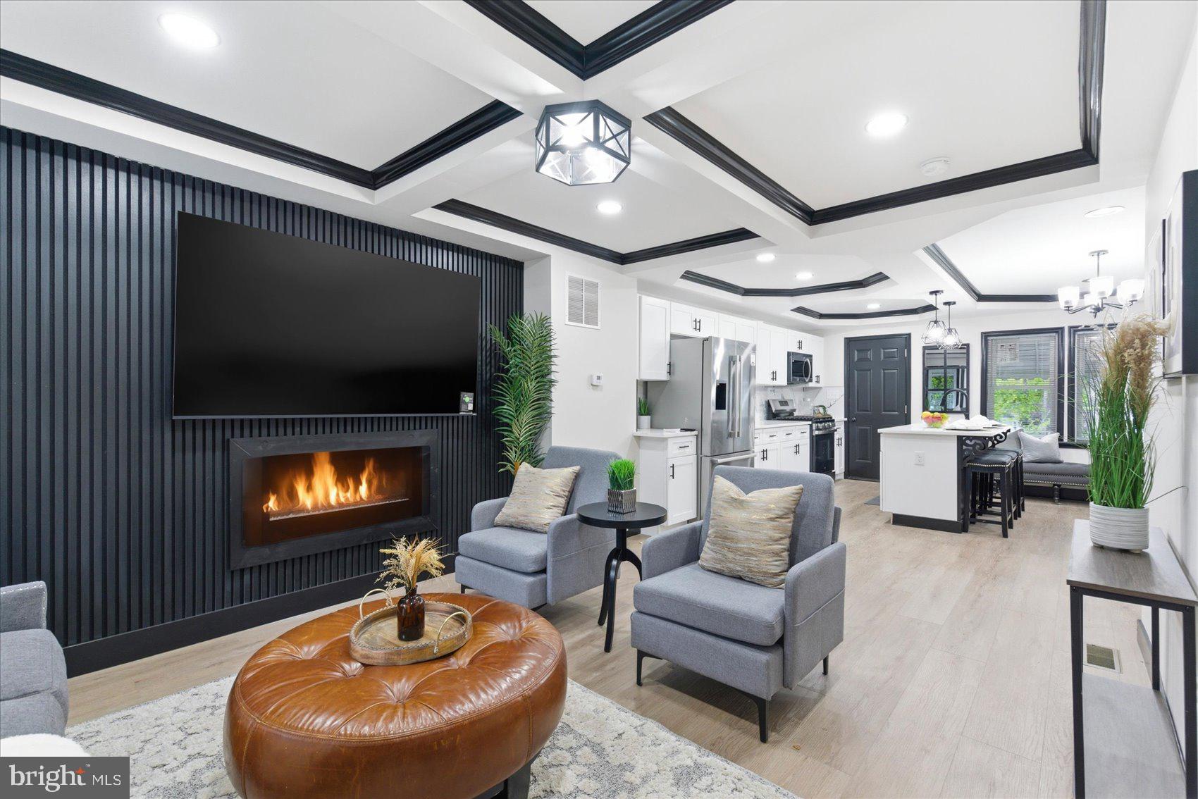 A complete transformation has taken place behind the door of this 4BR/2BA brick townhome, and from the moment you step onto the covered front porch, this one feels different. With an open front view and no homes directly across the street, the setting offers a rare sense of calm, space, and privacy. 
Inside, the home delivers style, drama, and function. The open-concept main level is filled with natural light and finished with a bold black-and-white design palette, luxury flooring, recessed lighting, statement fixtures, and a custom tray ceiling that immediately sets the tone. The spacious living room features a custom accent wall, fireplace insert, and mounted TV(that stays), creating a true focal point for everyday living or entertaining.
The dining area flows into a gorgeous kitchen designed to stand out, featuring ample cabinetry, stainless steel appliances, sleek quartz countertops, a striking backsplash, and a center island with pendant lighting, breakfast seating, and a stainless sink.
Upstairs, you’ll find three well-sized bedrooms, including a spacious primary bedroom, along with a full bath enhanced by a skylight. The finished lower level adds even more flexibility with a large family room, custom feature wall, fireplace insert, mounted TV(that stays), full bath, laundry area with new washer and dryer, storage, and a fourth room that can serve as a bedroom, office, guest space, or flex room.
Step out back to a large patio area ready for entertaining, relaxing, grilling, gardening, or creating your own outdoor escape with a private parking pad. 
With thoughtful updates throughout, generous living space, and a peaceful front-facing view that gives you breathing room, this home offers the kind of city living that feels stylish and private.