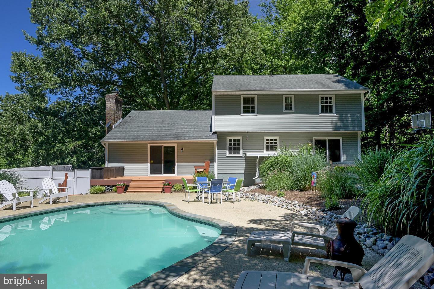 Turnkey home, and the seller says, "Let's get it sold." Welcome to your own private oasis in the highly sought-after Hunt Chapel community! Tucked away on 2.03 scenic acres with no HOA, this exceptional four-bedroom, three-and-a-half-bath Colonial offers the perfect combination of timeless charm, modern updates, and resort-style outdoor living. From the moment you arrive, you’ll be captivated by the peaceful setting, newly installed asphalt driveway, and beautifully maintained grounds that create the feel of a secluded retreat. 

The backyard is truly the showstopper—featuring an incredible Gunite in-ground pool surrounded by nature and designed for unforgettable summer gatherings, relaxing weekends, and everyday enjoyment. Whether entertaining guests or unwinding after a long day, this outdoor paradise offers privacy, tranquility, and endless possibilities.

Inside, the home is warm, inviting, and thoughtfully updated throughout. Hardwood flooring flows across the entire main level, staircase, and upper level, adding elegance and continuity to the home’s spacious layout. The updated kitchen, featuring granite countertops, updated cabinetry, stainless steel appliances, and an open design that seamlessly connects to the expansive family room with a cozy fireplace and beautiful views of the pool and backyard. Formal living and dining rooms provide the perfect setting for gatherings both large and small, while the main-level powder room adds convenience.

Upstairs, you’ll find four bedrooms and two full baths. Please note: The master bath and master closet could be expanded to the first smaller bedroom to provide an even bigger master bath and master closet. The partially finished basement offers valuable additional living space with endless potential for a recreation room, gym, theater, home office, or guest area—ready for your personal touch.

Step outside to enjoy peaceful mornings on the rear deck, evening dinners on the patio, or weekends spent entertaining by the pool while surrounded by a serene wooded backdrop. The expansive front, side, and rear yards provide plenty of space for sports, gardening, play, or future outdoor enhancements.

This home has been meticulously maintained with numerous major updates already completed, including an updated roof; new asphalt driveway (2026); high-efficiency 18.5 SEER HVAC system (2024); water heater (2018); pool pump; updated windows; relined chimney (2017); sump pump (2025); water conditioner (2025); new deck (2025); updated exterior siding; fresh interior paint; and generator hookup/setup for added peace of mind.

Ideally located with convenient access to shopping, dining, schools, and major commuter routes, this rare property offers the perfect balance of privacy, comfort, convenience, and exceptional outdoor living. Homes like this don’t come along often—don’t miss the opportunity to make this stunning retreat your forever home!