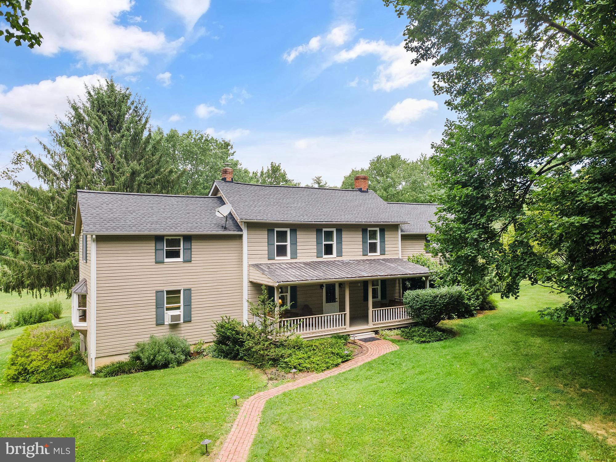 Open House THIS Saturday (7/25) from 11AM-1PM! What an astounding value for one of the most private, well appointed, charming homesteads in Carroll County! 252 Bachmans Valley Rd offers 3 bucolic acres down a long private driveway, with a timeless 2500+ sf original farm house flanked by a detached garage, barn, intricate, planned, and lovely landscaping and gardens, combining so much yesteryear country charm with the space and outdoor amenities buyers today are seeking. The home features a large front porch with countryside views sure to make the hours melt away. Enter to the eat-in kitchen on your left, and dining room on your right. There is an addition on either side of the home - through the dining room with its beamed ceiling, iconic original hardwood flooring, and fireplace, to the large family/living room featuring exposed log cabin walls that used to be the exterior of the home! A bay window and 4 others drench this spacious and cozy addition with natural light. The large, eat-in kitchen features ample cream cabinetry, room for a table, access to the basement, and a walk-out to the enclosed back porch, and beyond that the perfect deck for eating meals together or enjoying a beverage outside in the blissful quiet. The first floor addition on the northwest side of the home could be an additional bedroom, family room, office space, or whatever is needed with an equally impressive amount of windows and natural light. A walk-in storage closet adjacent features a washer/dryer hookup for first floor accessibility if needed. There is also a full bath with stand up shower on the first floor. Upstairs, find 4 large bedrooms, ranging in size from 12x8 to 2 that are 19x14 - with large closet spaces! The front bedroom contains walk-up steps to the attic, and the floorplan lends itself to flexibility, reconfiguration if necessary, and a myriad of living situations. Charm, care, and a colonial color palette are constant throughout the home with pride of ownership and decades of thoughtful touches apparent in every corner of the home. The basement has several partially finished spaces, the washer dryer, utility area, and provides so much room for storage. The recently upgraded electric panel, new well (2023), front porch (2026), and newer roof provide peace of mind. Outside, find an oversize 26' x 34' heated garage, big enough for 2-4 vehicles, complete with electric, windows, second story storage space, and perfect for a car, farm equipment, "anything with wheels" enthusiast, a workshop, or simply storage! The recently resided 20' x 36' barn features a gravel floor, large hayloft, chicken coop, greenhouse, and plenty of room, potential, and existing structure to customize it to be your own - whether than means adding stalls, more parking area, turning it into a studio, or more! Explore the gardens, appreciate the mature and curated plantings around the property, bring your animals home, watch your own flora and fauna flourish, and have your perfect piece of Americana country life right here in Westminster. 252 Bachmans Valley is waiting to continue to be adored by its next owners!