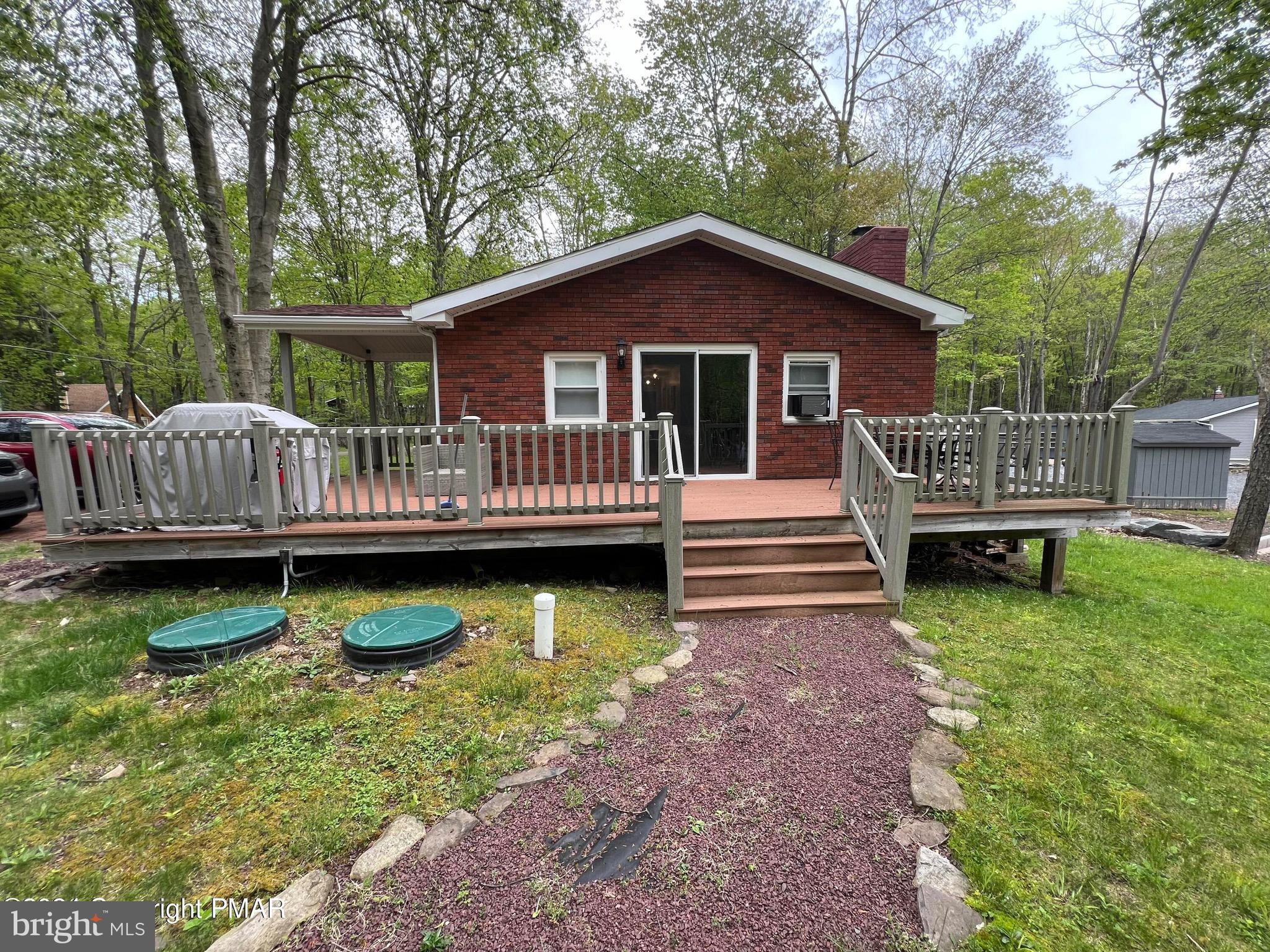 Enjoy the best of Arrowhead Lake living from this inviting corner property, just a short walk to the playground, boat launch, sandy beach, and lake activities.  This charming home offers easy one-floor living with an open, bright floor plan, updated flooring, and stainless-steel appliances. Relax beneath cathedral ceilings, cozy up by the living room fireplace, or unwind while enjoying the surrounding natural beauty.  Furniture is included, making this truly move-in ready. Need extra storage? A detached shed provides ample space for tools and outdoor gear.  Additional highlights include a covered entrance, attractive exterior, and strong curb appeal. The crawlspace has been professionally encapsulated for added peace of mind. Located in an Airbnb-friendly community with low taxes, this home is perfect as a year-round residence, vacation retreat, or investment property.