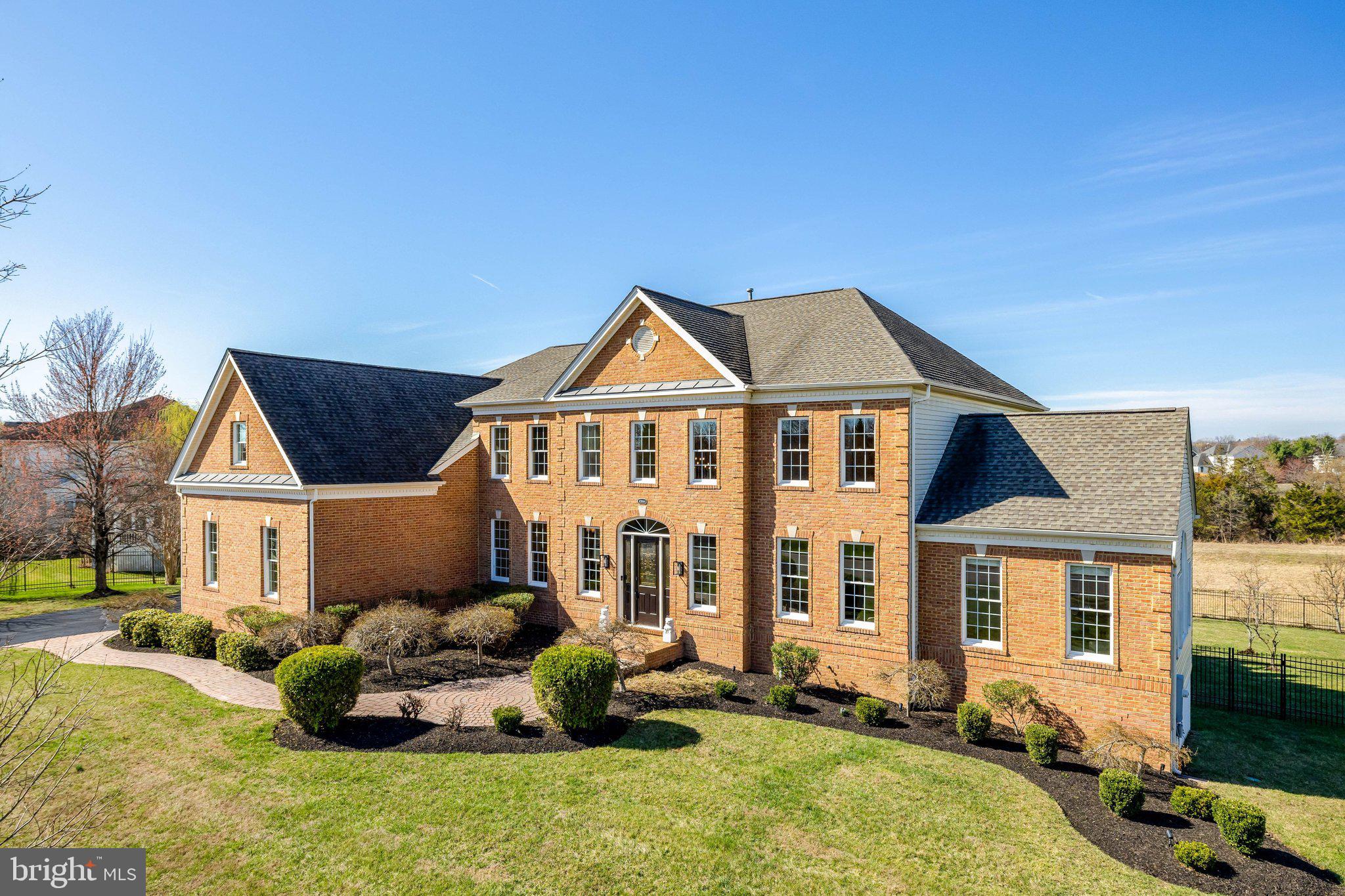 Set on a lush .93-acre homesite, this extraordinary 8,500+ sq. ft. Toll Brothers Henley Federal residence is a masterclass in scale, elegance, and modern refinement. A stately brick façade and beveled glass entry open to a breathtaking two-story foyer, where twin sweeping staircases establish a sense of timeless grandeur.
Every space has been thoughtfully curated—from the formal entertaining rooms with intricate millwork to the sunlit atrium retreat. At the heart of the home, the designer kitchen redefines luxury living, blending quartz surfaces, custom soft-close cabinetry, and a statement island built for gathering. The adjoining sunroom and expansive deck create a seamless indoor-outdoor experience.
The soaring two-story great room, anchored by a dramatic brick fireplace, offers both comfort and architectural impact, while a private library provides a quiet space for work or reflection.
Upstairs, the primary suite is a sanctuary unto itself—complete with a sitting room, an extraordinary 26-foot dressing room, and a spa-caliber bath crafted in porcelain and quartz. Each additional bedroom is a private suite, offering elevated comfort for family and guests alike.
The lower-level transforms into a full-scale entertainment destination, with a rec room, brick, gas fireplace, home theater, bar, finished storage/gym space, 2nd office, and 5th bedroom, full bath and additional guest accommodations.
Outdoors, the estate continues to impress with a fully fenced yard, mature fruit trees, professional landscaping, a 7-zone irrigation system and multiple spaces for gathering and relaxation.
With a 3-car garage, EV charging, smart home features, and a premier location near top-tier shopping, dining, and commuter routes, this home delivers an exceptional lifestyle at every turn.
