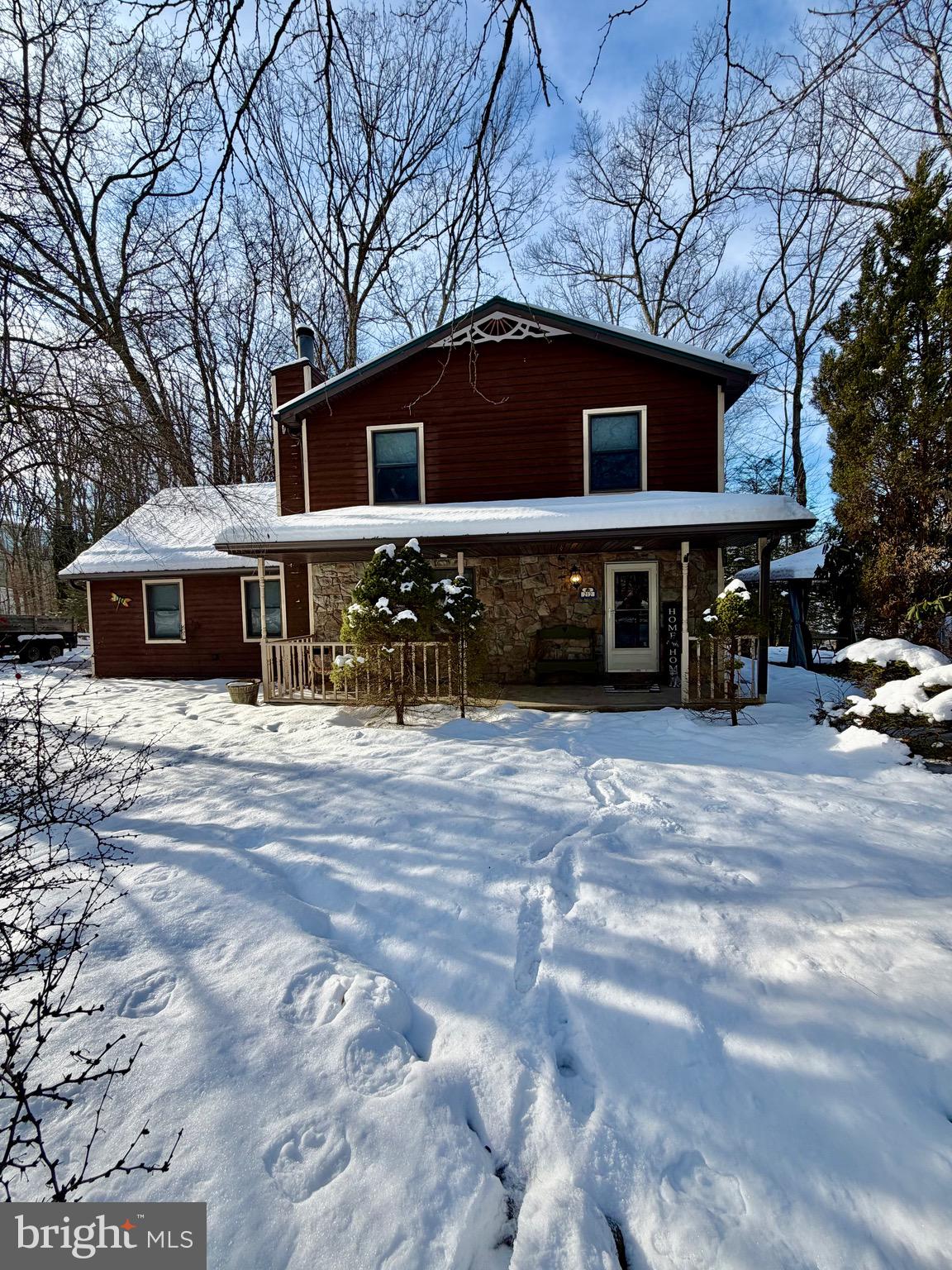 Discover the perfect blend of comfort, privacy, and resort-style living in this beautifully maintained 3-bedroom, 3-bath home located in the desirable Lake Adventure Community. Surrounded by mature trees and lush landscaping, this property delivers the true Pocono retreat experience while offering an impressive list of amenities right at your fingertips.

The home features a warm rustic exterior, a charming front porch, spacious bedrooms with vaulted ceilings, and a large primary suite complete with a soaking tub and double vanity. Enjoy cozy evenings in the inviting living areas or entertain family and friends with ease.
Step outside and indulge in everything the community has to offer: a private lake with white-sand beach, boat docks, tennis courts, shuffleboard, game room, restaurant patio overlooking the water, and 24-hour gated security for added peace of mind.

Whether you’re looking for a vacation home, an income-producing short-term rental (verify with HOA), or a full-time residence with year-round recreation, this property checks every box.