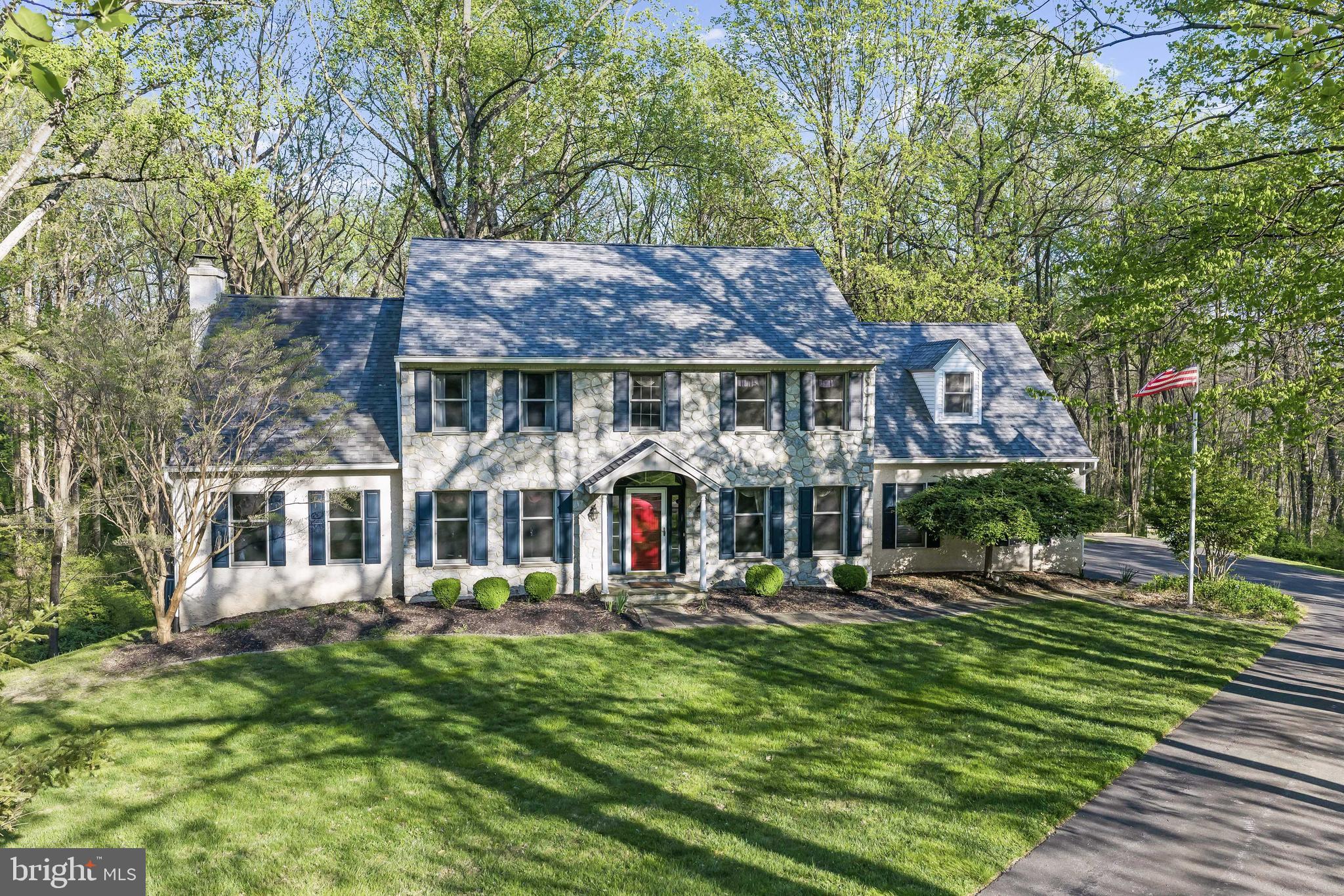 Tucked away at the end of a quiet cul-de-sac on a beautifully wooded lot, this stunning stone Colonial offers the perfect blend of elegance, comfort, and privacy—overlooking a serene neighborhood preserve. From the moment you arrive, you’ll appreciate the peaceful setting and timeless curb appeal. Step inside to a welcoming foyer with gleaming hardwood floors that flow throughout much of the main level. The heart of the home is the spacious kitchen, featuring abundant cherry wood cabinetry, a cooktop island with exhaust, a convenient built-in desk area, and hardwood flooring. The kitchen opens seamlessly to a bright breakfast room with sliders to the back deck, as well as a dramatic family room with a vaulted ceiling, a striking stone fireplace, and a wall of Palladian windows that flood the space with natural light. The main level also offers a private office with pocket doors—perfect for working from home—a formal dining room adorned with wainscoting and crown molding, a powder room, and a functional mud room leading to the expansive 3-car garage. Upstairs, the main bedroom suite is a true retreat, complete with a tray ceiling, double closets, and a spacious en-suite bath with double sinks and a glass-enclosed shower. Three additional generously sized bedrooms and a hall bath complete the upper level. The finished lower level adds even more versatile living space, including a bonus room, a large utility/laundry area, and an impressive game room with a full wall of built-in desks and cabinetry—ideal for hobbies, entertaining, or remote work. Sliders lead out to a lower patio and deck, offering yet another place to enjoy the tranquil surroundings. Roof was installed in 2014 with a 50 year transferable warranty. With its peaceful setting, thoughtful layout, and beautiful architectural details, this home is a rare opportunity to enjoy refined living in a truly picturesque location.