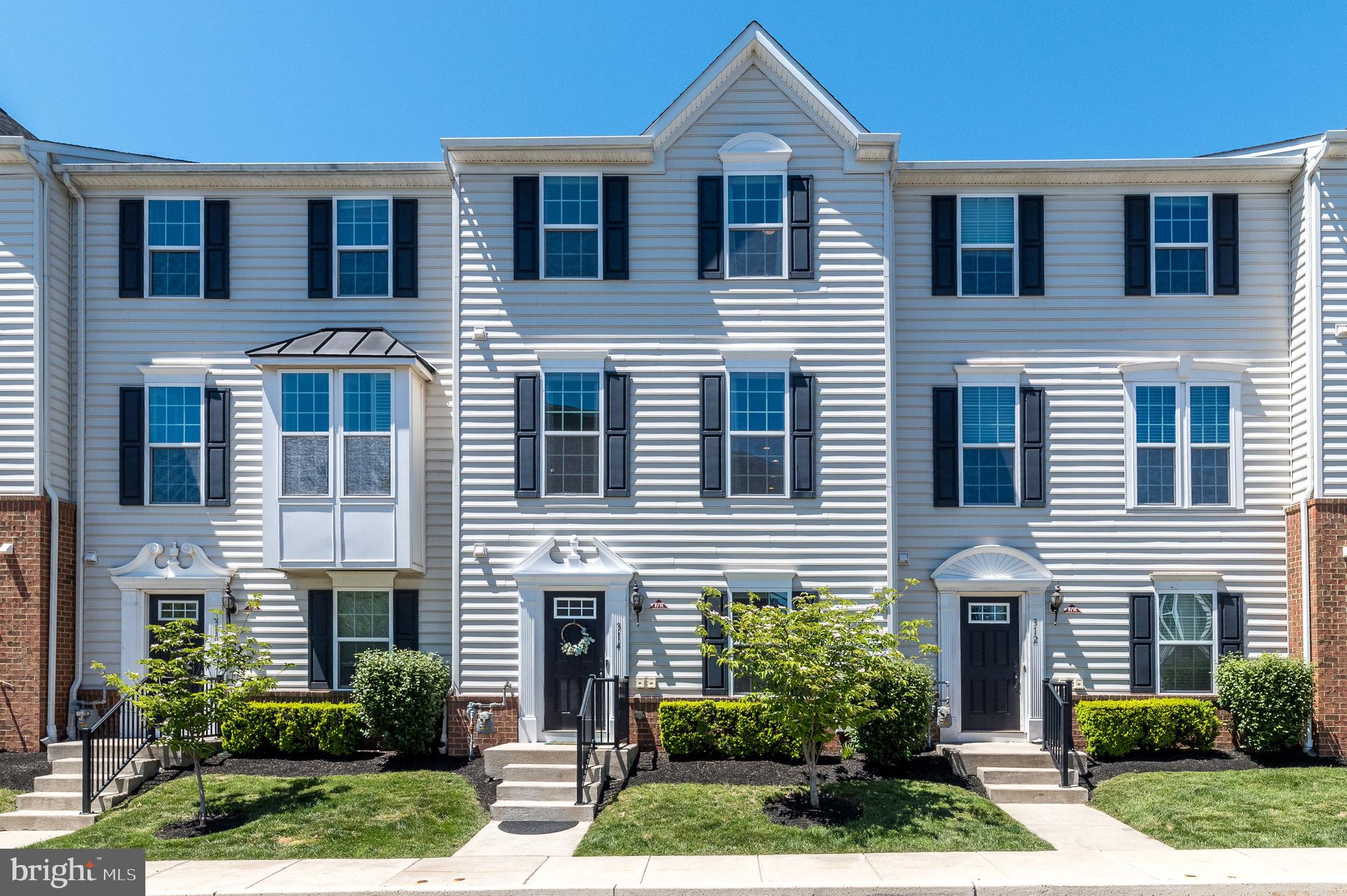 Welcome to 314 Almond Drive, a beautifully appointed Strauss Model Townhome built in 2016 by Ryan Homes, located in the highly sought-after community of Andale Green. This “better than new” home offers 3 Bedrooms, 2 Full and 2 Half Baths, a 2-car Garage, and a spacious 20’ x 10’ composite Deck with privacy wall—perfect for relaxing or entertaining. Filled with natural light, the home features an open, flexible floor plan with numerous upgrades throughout, including hardwood flooring, oak stairs, upgraded millwork, recessed lighting, ceiling fans, custom blinds, and energy-efficient systems. The entry level welcomes you with a gleaming black door into a Foyer with hardwood floors, a comfortable Family Room with carpeting and projector screen, a large walk-in storage closet (16’ x 10’), and interior access to the Garage with keypad entry, built-in shelving, and additional storage. A convenient Half Bath completes this level. The main living level showcases 9-foot ceilings and an open-concept layout connecting the Kitchen, Dining, area, and Living Room. The gourmet Kitchen features hardwood flooring, staggered Maple Cognac cabinetry, granite countertops, glass tile backsplash, a center island with seating and outlets, Breakfast Bar, and stainless steel appliances including a 5-burner gas range and built-in microwave with convection. The Dining area is enhanced by a custom built-in hutch with glass doors and granite top, along with sliding glass doors leading to the Deck. The adjoining Living Room offers hardwood flooring and crown molding, and an additional Half Bath is also located on this level. Upstairs, the spacious Owner’s Suite provides a private retreat with a tray ceiling, an oversized walk-in closet (16’ x 13’), and a spa-like Bath featuring tile flooring, a soaking tub, dual-sink vanity with granite countertops, and a tiled stall shower with glass inlay. Two additional generously sized Bedrooms share a Full Hall Bath with tile flooring and tub/shower. A conveniently located upper-level Laundry area with washer, dryer, and cabinetry completes the home. Award winning North Penn School District. Enjoy fabulous sunsets! Andale Green is located across from Stony Creek Park, with plenty of open space and walking trails. Walk to to shopping and restaurants, Close to downtown Lansdale, schools and farmers market. Near to the Northeast extension, routes 63 and 202. Walk to the Pennbrook Train Station. A terrific community to be part of! 1 year HSA home warranty included to the happy buyers! Schedule your showing today!