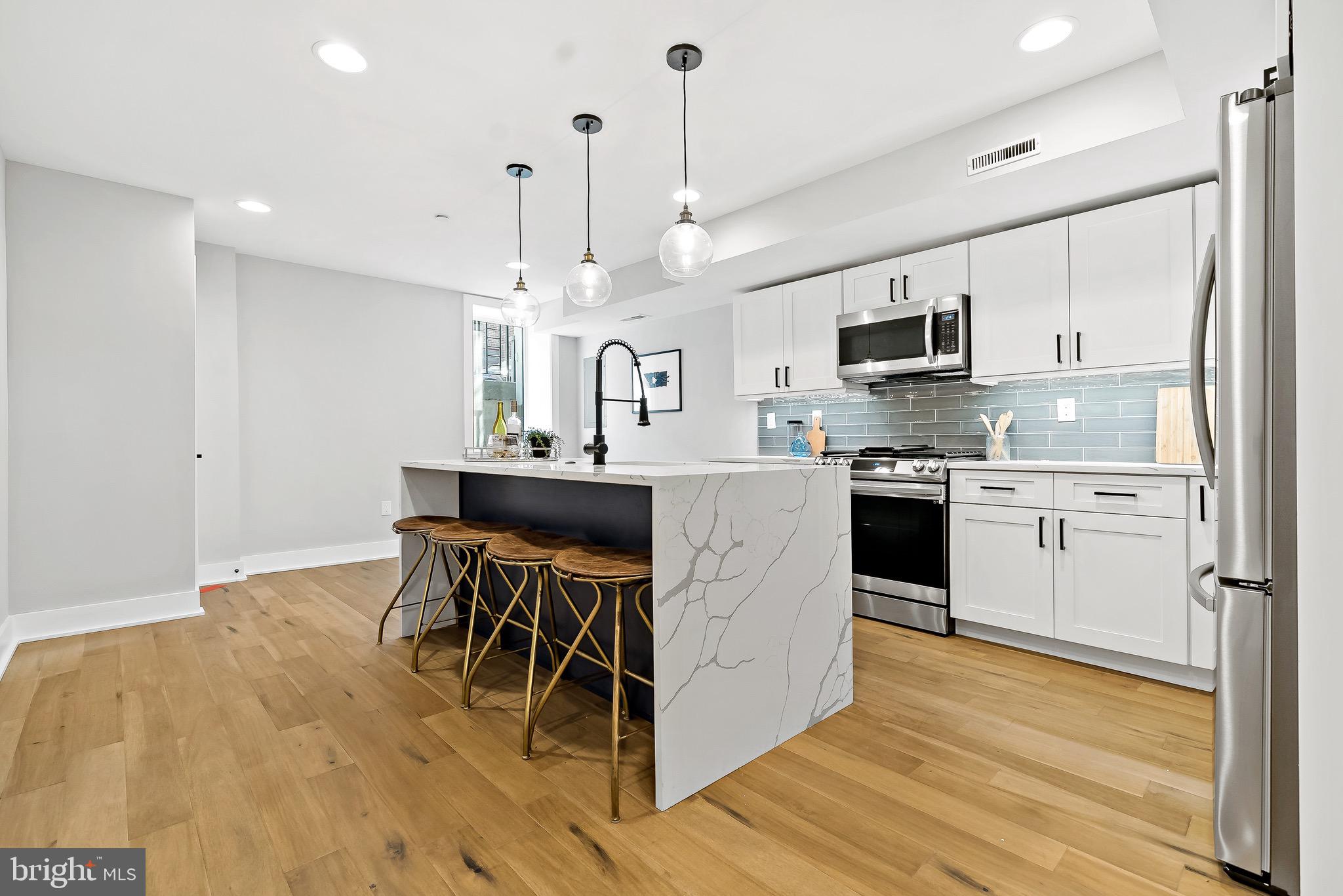 Welcome to Passyunk Place, beautiful new construction  development in the heart of Passyunk Square. These bi-level units offer an open floor plan filled with lots of natural light. Step inside to find wide plank hardwood floors, quartz countertops, white cabinets, and recess lighting, a built-in camera system with doorbell, and most importantly a 10-year Tax Abatement.

The main level features a front bedroom with closet space that also makes a great home office, along with a full bathroom, coat closet, and stackable washer and dryer. Toward the back of the home, you’ll find a spacious second bedroom with an ensuite bath located just steps from the rear door that leads out to the backyard. The lower level includes the kitchen as well as a half bath, storage, and a spacious living room. 

Located in a highly walkable neighborhood, you’re just steps from award winning  restaurants, cafés, and shops. A nearby playground, basketball courts, and open field add even more to love about this fantastic location.