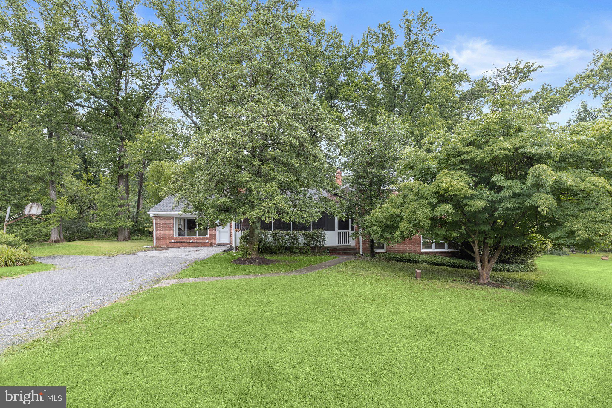 Introducing this spacious four bedroom, three bathroom home set on a 0.71-acre corner lot surrounded by trees for a peaceful setting in Pikesville. As you arrive, a screened porch provides an inviting welcome and is the perfect spot to relax outdoors. Inside, the front living room boasts a cozy gas fireplace and crown molding that continues into the formal dining room with sliding glass doors out to the rear patio. The kitchen is equipped with stainless steel appliances, granite counters, a tile backsplash and a breakfast bar for casual meals. A large family room offers another space to lounge or entertain guests. Up a few steps, the primary bedroom has two closets, one of which is a walk-in, and a private en-suite bathroom with a walk-in shower. Also located on the upper level are two additional bedrooms and a shared full bathroom. Downstairs, the lower level expands the living space with a recreation room. The fourth bedroom, third full bathroom and utility room with laundry complete the lower level. Outside, enjoy relaxing and taking in the surroundings in the expansive backyard with a convenient shed for storing outdoor essentials.