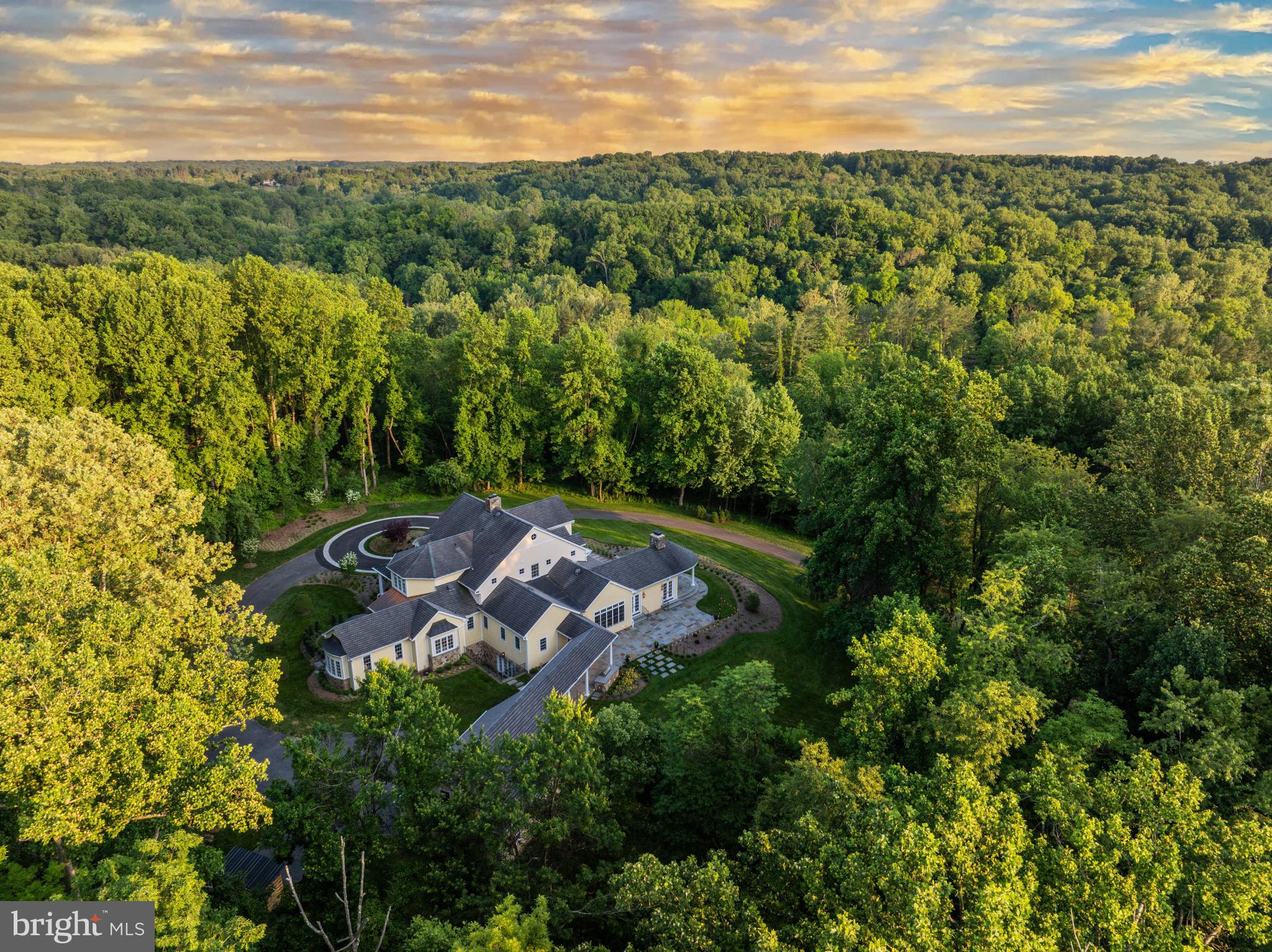 Live authentically. Sculptural and enduring design by celebrated architect Sarah Crosby Schweizer orchestrates a light filled and rich connection with sense of place. Perched on a tranquil 12.55 acre, magical setting enriched with glorious morning and afternoon golden light. A symphony of elements dance together masterfully. Your sanctuary… a nature lovers haven. This setting invites you to reconnect with the circadian rhythms of life. Your sense of arrival is heightened with a cobblestone bordered circular drive. Original build in 2007, elevated and all encompassing renovation in 2023 realized by the talented builder John Tiralla. Breathtaking and impeccable interiors by Darrian Mariaca. Textural clean palette with an earthy and refined aesthetic. Design elements you will swoon over include lighting by Kelly Wearstler and Thomas O'Brian. Phillip Jeffries and Holly Hunt's artful wall coverings will lift your every day. Quarter sawn oak floors provide visual continuity. Be inspired in your divine state of the art luxury cooking space. Amish custom built square edge inset cabinetry, black walnut island and Armac Martin custom hardware provide its own sensory experience unto itself. Pure blissful satisfaction. The handsome mahogany butlers pantry of your dreams and a hyper ergonomic dry pantry will keep your culinary creations and imbibing on point. Flow seamlessly and dine al fresco on majestic and inviting circular bluestone terrace. Pause and enjoy the stillness. Crackling  fireplace. Endless panoramic vistas. Framed views. Outdoor grilling station positioned perfectly. Sauté under the stars. Elegant and airy dining room flanked by wall of glass beckons for lively conversation well into the evening. Custom 12 x 22 bike barn. You'll wonder how you ever lived without one. Hop on your bike and pedal to the trail, an effortless and enjoyable five lymph boosting minutes away. The NCR trial is yours for cycling, running and hiking. Incredible access to Gunpowder State Park and falls. Fish and commune with nature. This property offers unrivaled proximity to life enhancing opportunities to keep you vibrant and happy. A destination primary suite invites deep sleep and an indulgent bathing and dressing experience. Lower level is an entertainers oasis with wet bar, leather countertops, butler stone fireplace, wine room and light filled french doors that take you right to main level to join in the outdoor living festivities. Intentional, thoughtful design is palpable. Master landscaping plan created by renowned Landscape Architect Jonathan Ceci, artistically curated design to delight in every season. Maxalea installation. Superior craftmanship and attention to detail. Sumptuous and meticulous all at once. Embrace the Monkton lifestyle. A zippy 15 minutes to Wegmans and Hunt Valley Towne Center. Cultivate your existence. The art of uniting human and home.