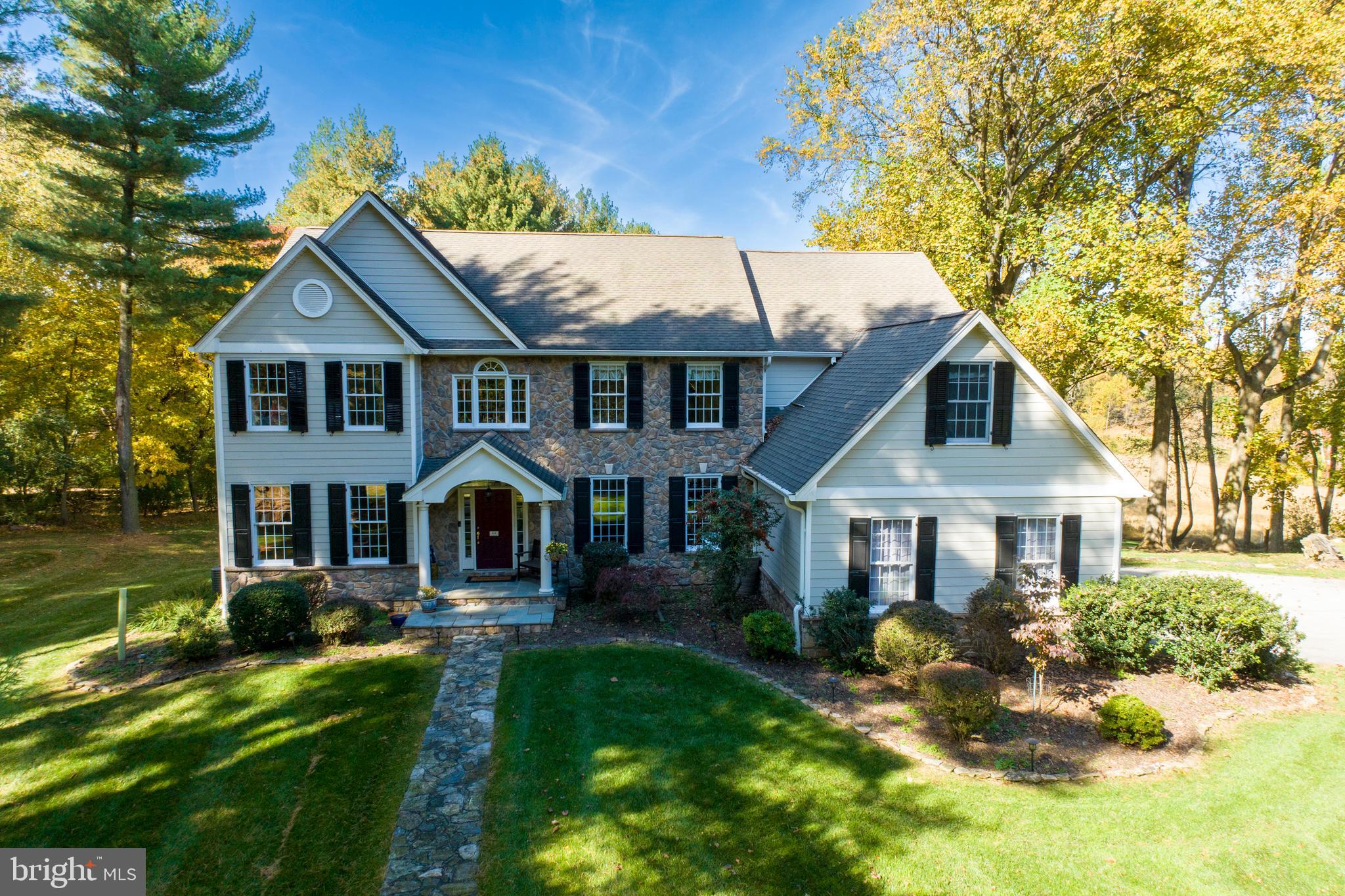 Welcome to 451 Webb Road in Chadds Ford Township! Not often does this combination of location and superior home come on the market. This incredible 6 bed, 4.1 bath home sits on 2+ secluded acres with dramatic views over Brinton Run Preserve, which features 70+ acres of preserved green space that include walking trails and also saw some of the action during the Battle of the Brandywine.  Located in the blue ribbon Unionville-Chadds Ford school district, the location offers lots of privacy while retaining easy access to shopping and destination sites such as Longwood Gardens, Winterthur, and the Brandywine River Museum. Privacy and serenity abound as you pull into the driveway and take in the mature trees and attractive landscaping. The exterior features updated masonry and Hardie plank siding (2019), as well as an inviting slate front porch that beckons you into the home. Stepping inside, you will immediately notice the gorgeous hardwood floors that run from the bright and airy foyer throughout the main level. The dining room to your right boasts intricate crown molding and wainscoting and is the perfect spot to host festive gatherings. Passing the butlers pantry into the kitchen, your eye is immediately drawn to the gleaming granite countertops and spacious, two-tiered island with plenty of seating to keep you in the conversation while hosting. With stainless steel appliances and a walk-in pantry for incredible storage space, the kitchen is ready to serve all of your needs. A separate laundry room off the kitchen, leads to the side door and the 3 car garage with built in storage space. From the breakfast area you can step through new sliders onto a huge new low maintenance deck (2023) overlooking the backyard and Preserve. Take in morning sunrises to evening sunsets and easy access to the backyard down the steps. The kitchen and breakfast area are open to the sunken family room, with custom Italian tile flooring (2020) and a jaw-dropping stone fireplace with gas insert (2022). Tall windows in the family room give you the perfect vantage point for the most spectacular views in Chester County.  On the main level is a large office and custom designed half bath. The living room completes the main level with custom crown molding and large windows to draw the natural light in. Upstairs, your personal oasis awaits in the generous primary bedroom suite with tray ceiling and room enough for a comfortable sitting area. Through french doors from the primary bedroom is a bonus room - nursery, 2nd office, workout space - you decide. The customized walk-in closet (Closets by Design) is next to the master bath - this has been upgraded with mahogany and marble vanities, vessel sinks, a soaking tub and a separate water closet. Down the hall, you will find four more generous bedrooms. Two of the bedrooms are joined by a Jack-and-Jill bathroom with updated granite and fixtures. The third full bathroom has dual sinks and serves the two remaining bedrooms. Downstairs, the expansive full daylight basement is the hangout spot of your dreams including a media room with hardwood floors, dry bar and dining area with Italian slate floors, and walkout access to the stone patio for relaxing summer nights. The patio leads to the stairs leading to the upper deck or a stroll down to the back of the property to the firepit and the Preserve. A sitting area, sixth bedroom and full bath in the basement would make a great spot for your guests, an in-law suite, or an exercise room. A large unfinished area allows easy access to all the mechanicals, loads of storage and also space for a crafts area. Other great features include the whole house vacuum and radiant heat that flows throughout the entire home, including the basement, keeping the floors and entire house warm in winter and cool in summer without the issues of forced air heat. In addition, the sellers have a home warranty that is transferrable to the buyer. Check out the video tour and schedule yours today!