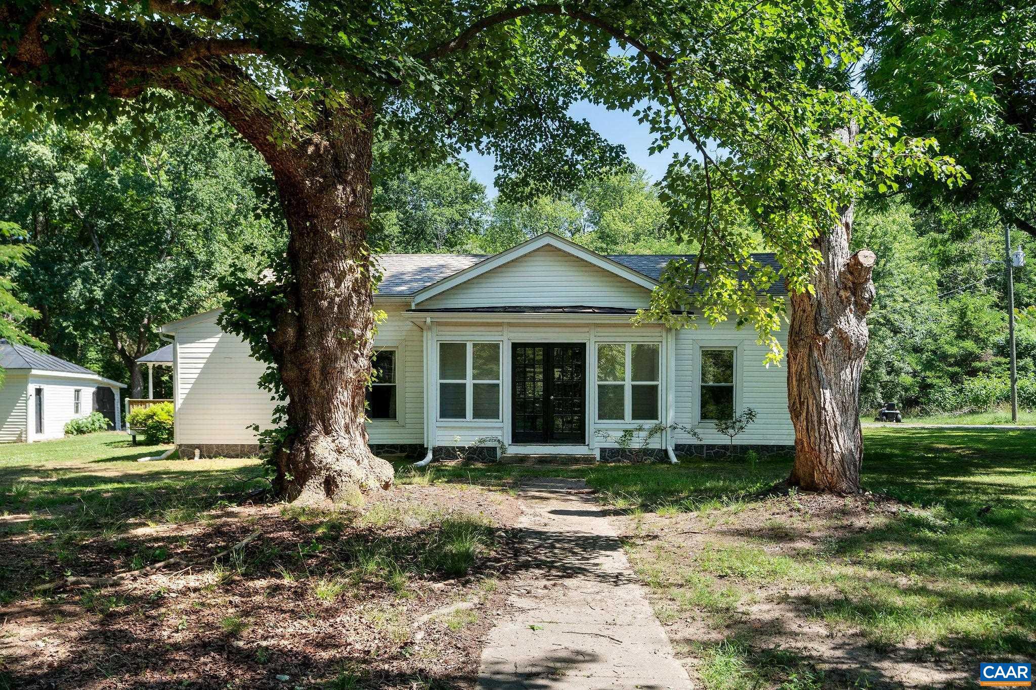 Welcome to Your Own Private Country Retreat on 3+ Beautiful Acres FEATURING TWO HOMES!! The main residence is move-in ready & has been thoughtfully updated, while the rear cottage (with attached fence) offers additional possibilities & is being sold as-is. Inside the main home, features include a remodeled kitchen with granite counters, white cabinetry, pantry storage & newer ss appliances. Recent improvements include newer windows, fresh interior paint, updated LVP flooring/carpet & beautifully renovated bathrooms featuring new vanities, counters, fixtures, flooring, & commodes. Bluetooth-enabled lighting allows you to stream music, podcasts & audiobooks. The spacious floor plan offers comfortable guest bedrooms with a charming nook perfect for play/reading The primary suite features a walk-in closet and private en-suite bath. A convenient mudroom with washer & dryer that conveys with the home. Enjoy outdoor living from the large deck with awning, generator hookup & peaceful views of the surrounding property. Level lot with a canopy of mature trees, established landscaping & apple, peach, and plum trees. Additional storage sheds with plumbing & electric. Firefly high-speed fiber internet & convenient Amazon next-day delivery.,Granite Counter,White Cabinets