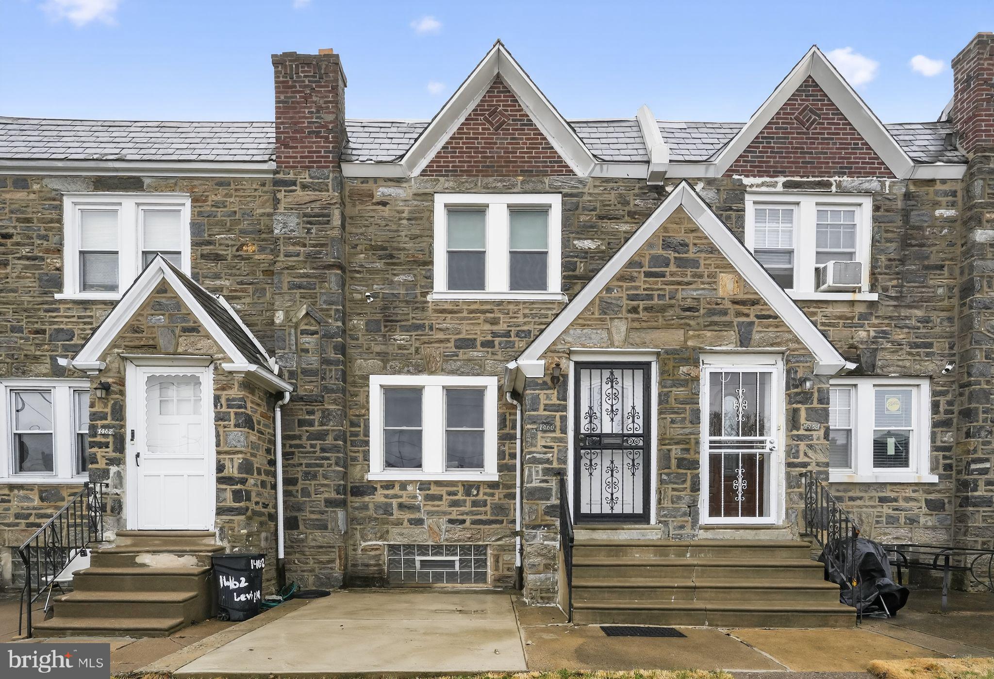 Stunning & Modernized Stone Row in Castor Gardens
Welcome home to this impeccably maintained and freshly painted stone row home , offering a perfect blend of classic Philadelphia charm and high-end modern updates. The curb appeal begins with the handsome stone facade and a new  front patio, while the interior welcomes you into an airy, open-concept main floor. This level features plush carpeting with original hardwoods hiding beneath, elegant arched transitions, and a gourmet chef’s kitchen complete with warm wood cabinetry, Corian countertops, a mosaic tile backsplash, and premium stainless-steel appliances—including a French-door refrigerator, a convenient computer desk and an abundance of custom shelving. 
The upper level continues to impress with three versatile, sun-drenched bedrooms and a spa-inspired full bathroom. The bedrooms are move-in ready with neutral tones and custom built-ins; the primary suite offers a stylish ceiling fan and wall-mounted TV hookups, while the secondary rooms feature incredible floor-to-ceiling shelving perfect for a home office or library. The bathroom is a true retreat, showcasing a custom walk-in shower with designer tile work, oil-rubbed bronze hardware, and a matching dark-wood vanity for a cohesive, luxury feel.
The functionality extends to the finished lower level, which serves as a massive flex space for a family room, gym, or guest suite. This level is enhanced by a convenient updated half-bath and a dedicated, spacious laundry room with plenty of storage. Complete with an attached rear garage and private driveway parking, this home offers the ultimate Northeast Philly lifestyle. Located just minutes from shopping, dining, and transit, this turnkey gem is ready for you to move right in and enjoy!