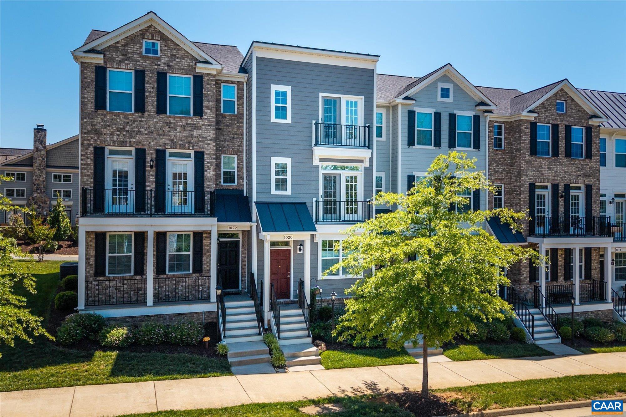 One of the only 2-bedroom townhomes available in Old Trail ? and one of the newest. Built 2021. Three stories, 1,613 finished sq ft, Arts & Crafts exterior with Hardie Plank and brick. Every level delivers: a full bath and flex office or guest suite on the entry floor; a designer kitchen with Bosch and KitchenAid appliances, granite, subway tile, and recessed lighting on the main, opening to a private composite deck with tree-lined views; two full bedroom suites with walk-in closets and private baths on the top floor, including a primary with frameless 10mm glass shower and dual vanities. Solar-tinted insulated windows, designer treatments, hardwood and tile floors throughout. Two-zone heat pump, Ecobee thermostat. Washer/dryer convey. Rear one-car garage plus driveway parking for two. HOA $306/quarter ? yard, snow, trash included. Walkable to shops, restaurants, and all three schools. Brownsville/Henley/Western Albemarle.,Wood Cabinets