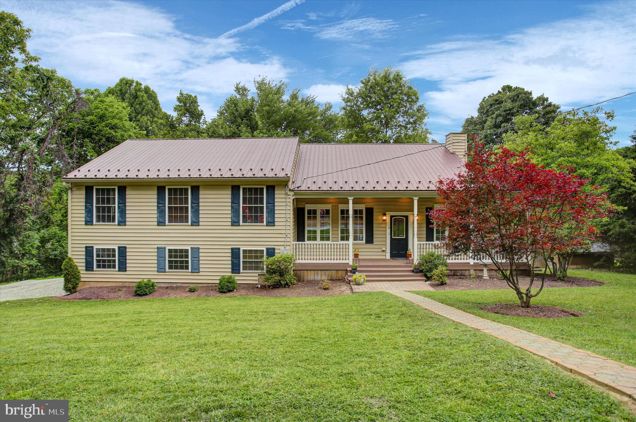 This completely custom built 4 bedroom 2.5 bathroom home on a private, wood-lined, half acre lot truly feels like a resort lodge! From the solid wood doors and trim to the super deep window wells to the unique lighting fixtures, this home has features you won't find in your average construction build!  The main level boasts an open floor plan with tall ceilings that allows for so much natural light and views of nature from every angle!  The massive kitchen is accented with custom stone tiles, unique shelving, a deep pantry, and windows installed in an L-shape behind the sink to make dishwashing a little more enjoyable! On the dining room wall you will notice access to the chimney incase you wanted to install a cozy wood stove which would add to the lodge-like feel inside!  The living room opens to the covered back deck which wraps around to the front of the house offering views of trees and wildlife! The upper level features a loft for additional family gathering space, 2 bedrooms with custom window seats, a full bath off the hallway, and a spacious primary suite!  The primary bedroom features 2 separate closets with one closet having two doors for access. There's even french doors incase you want to add a private balcony!  The primary bath offers a double vanity, custom shelving, and a tub/shower combo.  The lower level features another bedroom (or it could make a great office with the custom shelving wall), a half bath with rough plumb for a shower, a laundry/utility room, and an oversized 2 car garage that's fully finished and has custom lighting if a workshop is desired.  Time just seems to slow down when you relax on the back porch and enjoy the views and sounds of nature all around.  There is an older storage building in the backyard that has electric run to it. There are so many more features to talk about but come see for yourself and grab a flyer with all the details!