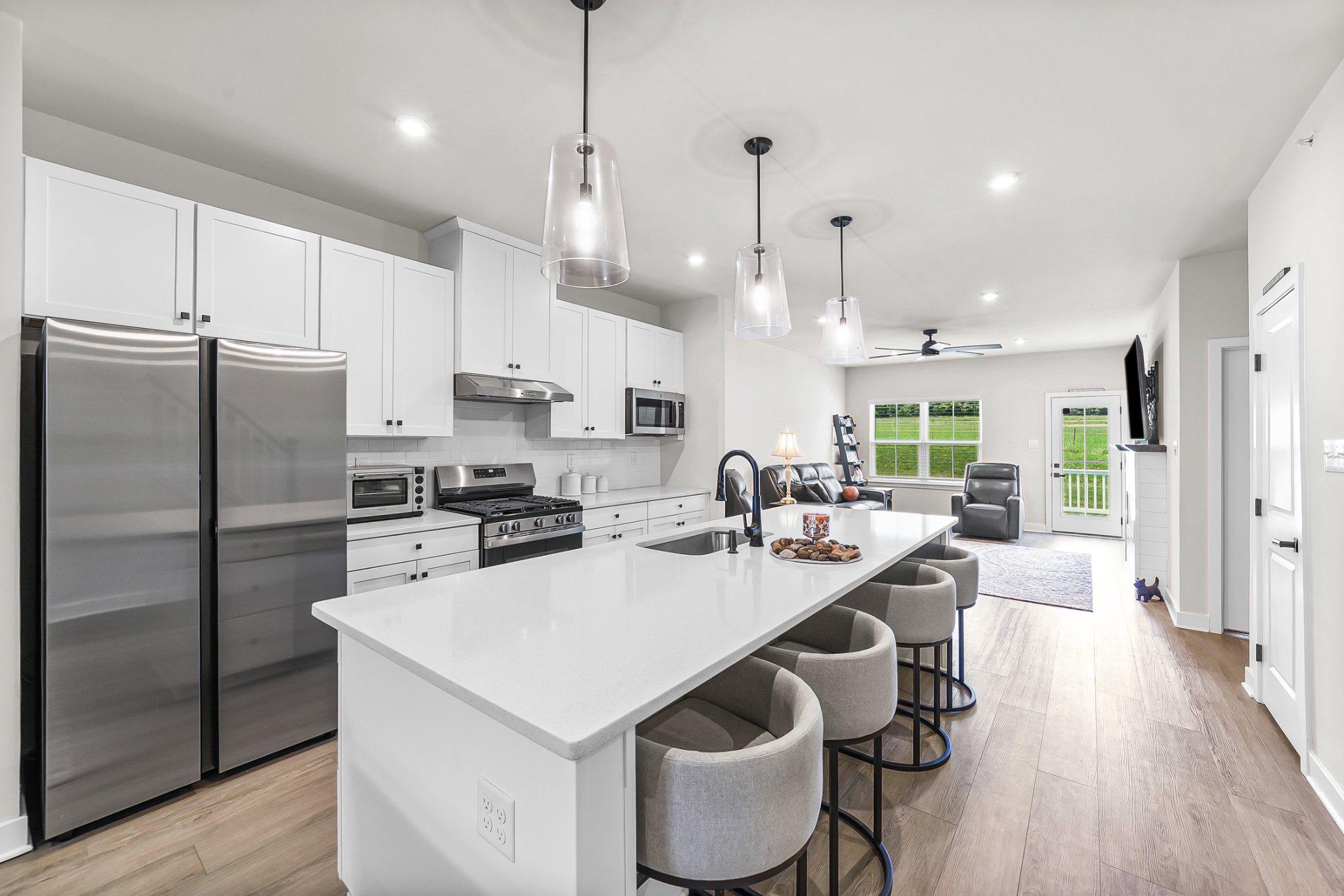 Featuring $100k in upgrades, a first floor primary and fully finished lower level! Available now in Brandywine Walk, a premier 55+ community.

This nearly new Caroline end-unit offers the space, upgrades, and low-maintenance lifestyle buyers want without waiting on new construction. Set on a premium lot backing to open space, this 4-bedroom, 3.5-bath home features main-level living, a first-floor primary suite, an open kitchen and family room, a 2-car garage, and a Trex deck with western exposure.

The kitchen is bright, upgraded, and highly functional with quartz countertops, soft-close cabinetry, an oversized island, upgraded lighting, Samsung appliances, and easy flow into the dining and family room. The main level also includes laundry, a guest powder room, generous storage, and a custom electric fireplace feature that anchors the living space.

The layout offers real flexibility. Upstairs are two spacious bedrooms, a full bath, and a finished den ideal for an office, reading room, hobby space, or guest overflow. The finished lower level adds a large recreation area, additional bedroom, full bath, workshop/storage space, utility upgrades, and hardwired data outlets.

With $100K+ in upgrades, 2-zone HVAC, EV charging, garage storage, and a premium end-unit setting backing to open space, 1623 Hydrangea Way is a rare opportunity to move right into one of Downingtown’s sought-after 55+ communities without the construction timeline.