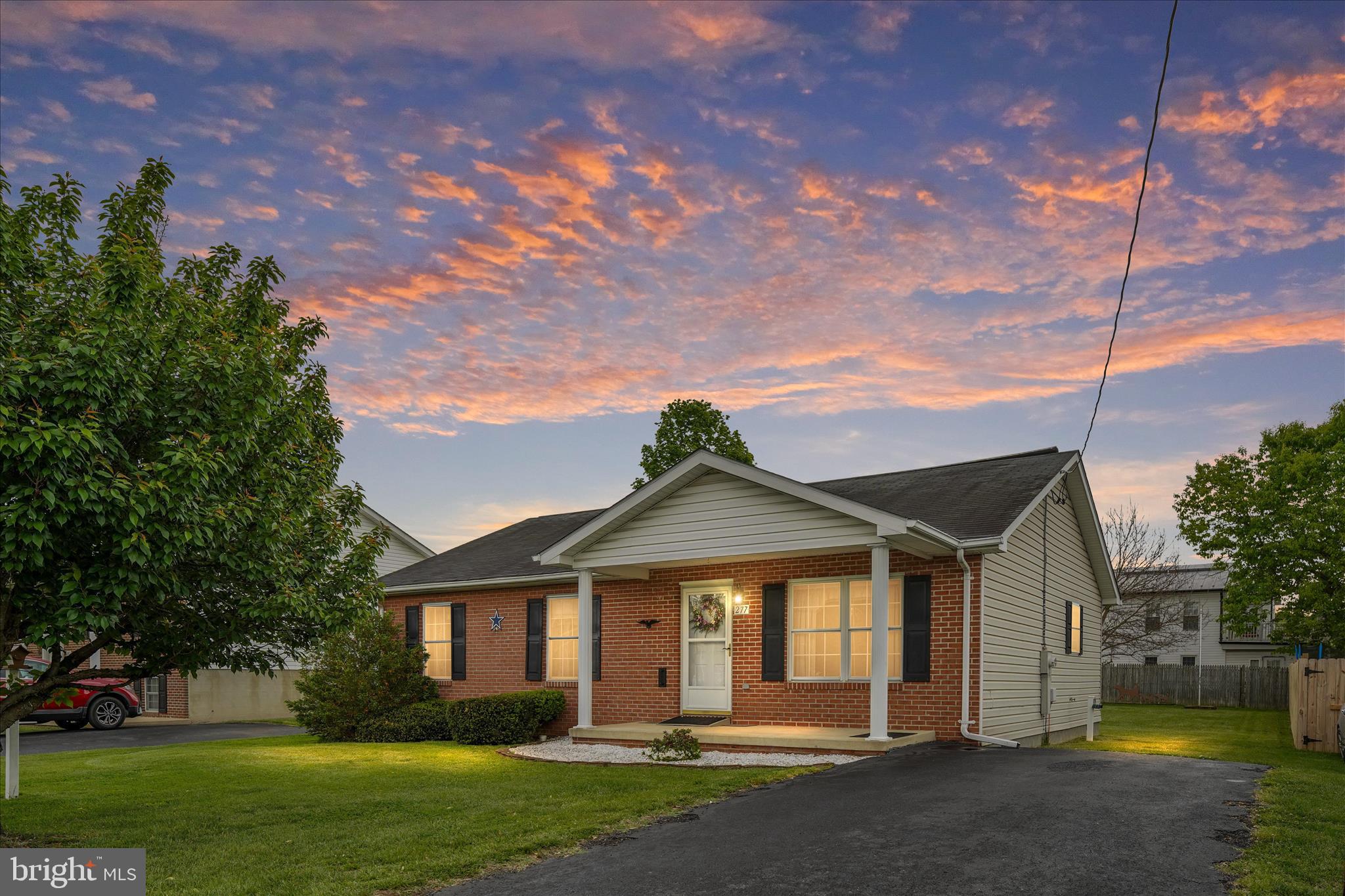 Well-maintained brick rancher offering easy one-level living! Enjoy a paved asphalt driveway, covered front porch with classic columns, and a spacious backyard complete with a shed. Inside features 3 bedrooms and 2 full bathrooms, including a generously sized primary suite with a private ensuite. The kitchen offers white appliances, an island with added cabinet space, and a convenient laundry area just off the kitchen. The dining room features hardwood flooring and opens to a 12x12 rear deck—perfect for relaxing or entertaining and great views!  HVAC is only 5 years old!