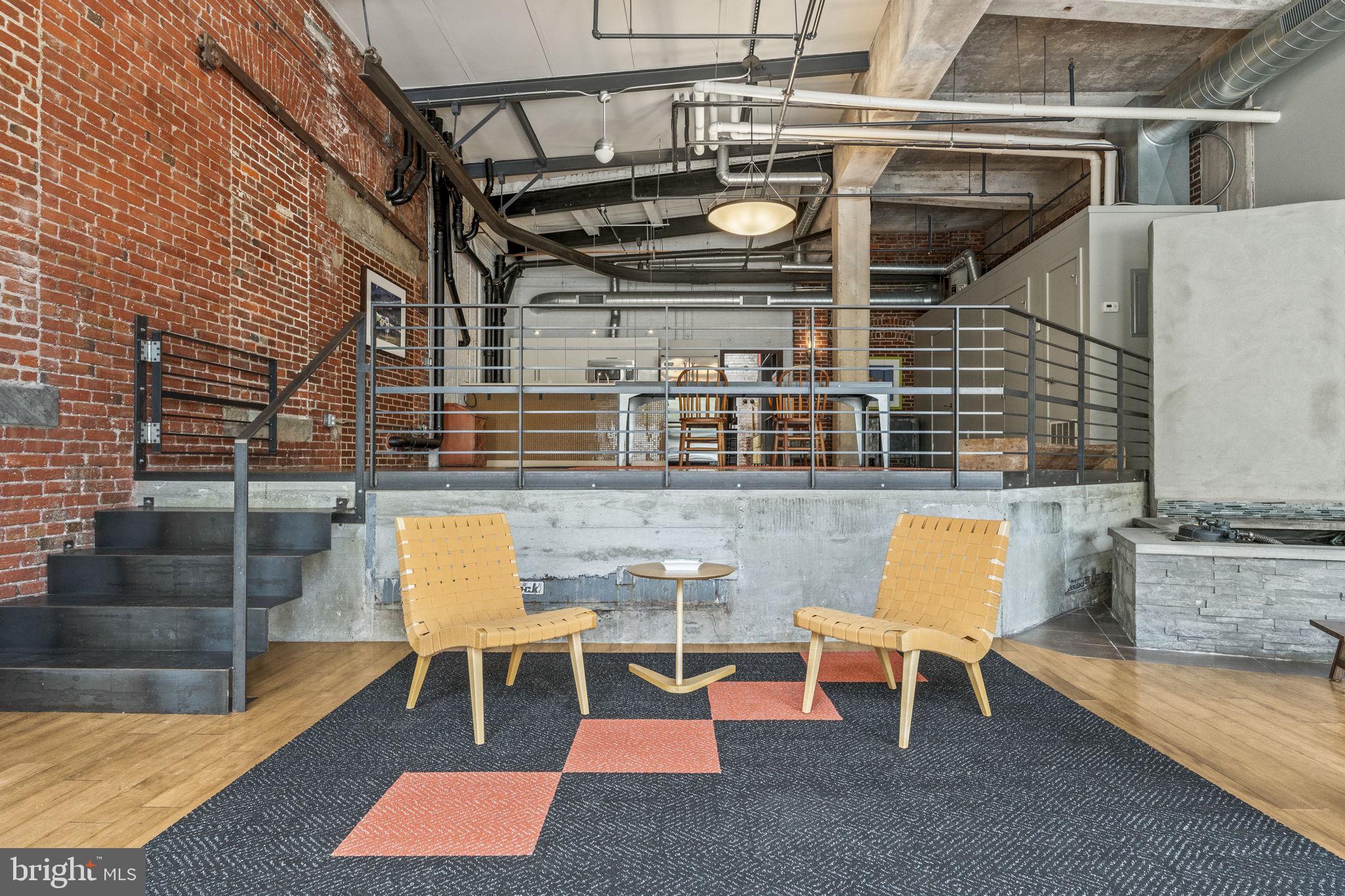 Rarely available and truly one-of-a-kind, this stunning Callowhill District bi-level dream loft includes two deeded parking spaces, two private entrances, and expansive open living spaces with soaring ceilings throughout.

Offering exceptional flexibility, this oversized residence is currently configured as a 2-bedroom home with a spacious room that can easily function as a third bedroom, home office, gym, creative studio, or guest suite. The dramatic scale and industrial-inspired design including exposed brick, custom-built staircases, railings, and dining table create a living experience rarely found in Philadelphia.

Enter directly from Noble Street or through the private parking garage for unmatched convenience and privacy. Inside, the open-concept floor plan is move-in ready and finished in a timeless neutral palette, featuring motorized electric shades, a fireplace, abundant storage, and a generous walk-in closet.

Designed for both everyday living and entertaining, the chef’s kitchen is equipped with professional-grade Viking appliances and seamlessly flows into the expansive living and dining spaces. True to the home's creative spirit the lower level features a striking indoor koi pond that serves as a tranquil focal point. Bringing a sense of calm and artistry to the free flowing space. Flooded with natural light and offering endless possibilities for customization, this home provides the perfect canvas to create your own distinctive urban retreat.

Ideally situated in the heart of Callowhill, just steps from the Rail Park and moments from acclaimed restaurants, coffee shops, boutiques, and nightlife. Enjoy effortless access to Fishtown, Old City, Center City, Museum Mile, public transportation, and I-95, all while living in one of Philadelphia’s most vibrant and sought-after neighborhoods.

A rare opportunity to own a true artist’s loft seamlessly blending scale, character, privacy, exceptional flexibility, and convenience.  (Main entrance is at 1234 Noble St. #105)