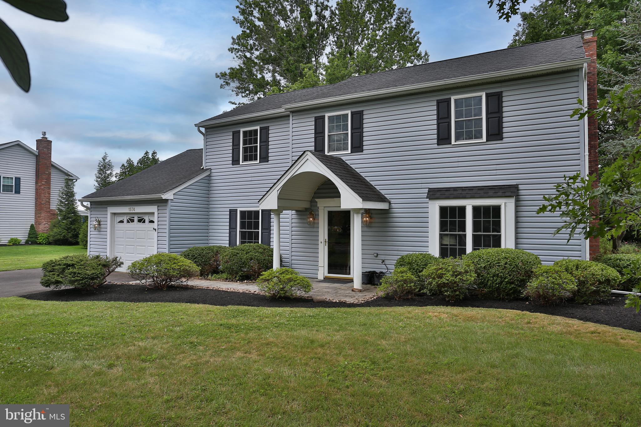 The attractive curb appeal of this nearly 2,200-square-foot Colonial welcomes you home, whether you're a first-time buyer or looking to downsize without sacrificing space. Ideally situated adjacent to the premier shopping and dining destination of Valley Square, you'll enjoy countless restaurants, shops, and convenient access to major commuter routes. Set on a quiet, picturesque .46-acre lot, the property is surrounded by mature trees and beautiful perennial gardens, creating a peaceful retreat. Relax year-round in the glass-enclosed sunroom while taking in the tranquil views of the private backyard. Inside, the classic center hall layout offers both timeless character and comfortable living. The updated kitchen features crisp white cabinetry, quartz countertops, a center island, new range, and a sunny breakfast area, all opening to the spacious family room with a cozy brick wood-burning fireplace with side built-in cabinetry. The formal living and dining rooms showcase classic wood trim details that add warmth and elegance to the spaces. Upstairs, you'll find four generously sized bedrooms, including a spacious primary suite complete with a walk-in closet and private ensuite bath. Offering tremendous value in a highly desirable location, this appealing home also provides peace of mind with major updates already completed, including a newer roof and replacement windows. Move right in and personalize the finishing touches over time to truly make it your own. Don't delay, schedule your private tour today!