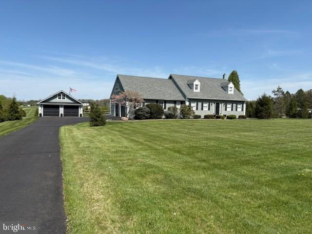 This custom-built Cape Cod offers 3 bedrooms and 2.5 baths on 3 acres of serene open space. From the moment you arrive, the home’s curb appeal stands out with well-maintained landscaping and grounds. A long driveway leads to the attached garage, which offers interior access and convenient entry to the kitchen.
The detached second garage provides ample space for additional vehicles, including classic cars, recreational equipment, or other storage needs. Its expansive upper level adds flexible space for storage, a workshop, or hobby use.
Step inside to a hardwood foyer and staircase accented by quality woodwork. Hardwood flooring extends throughout the first floor and is complemented by crown molding. The spacious, light-filled living room flows into the dining area and well-appointed kitchen, which features a stainless-steel refrigerator, new oven and stove, solid wood KraftMaid cabinetry, granite countertops, and a pantry. Just off the kitchen are a half bath and a large laundry room with a utility sink, washer, dryer, and additional storage. This space also includes exterior access, making it ideal for use as a mudroom.
The first-floor primary suite offers privacy and comfort, with a spacious bedroom filled with natural light. The en suite bath includes a soaking tub and a separate standing shower, creating a peaceful retreat.
Just off the kitchen, the sunroom features a ceramic tile floor, ceiling fan with light, and multiple glass doors with privacy curtains, offering a bright and versatile space to relax or entertain. Upstairs, two spacious bedrooms provide large closets and additional storage. The full bath includes a large tub, updated flooring, and an attractive vanity and countertop.
The full unfinished basement is clean, dry, and well maintained. It includes a water softener system for the well, 200-amp electrical service, two-zone heating for efficiency, and quality insulation throughout the home.
Outside, the setting feels private and peaceful, with sweeping long-distance views and beautiful sunsets. Split-rail fencing adds charm and flexibility for a variety of outdoor uses.
This distinctive property offers a rare combination of space, comfort, and versatility. Schedule your tour today to experience all it has to offer in person.