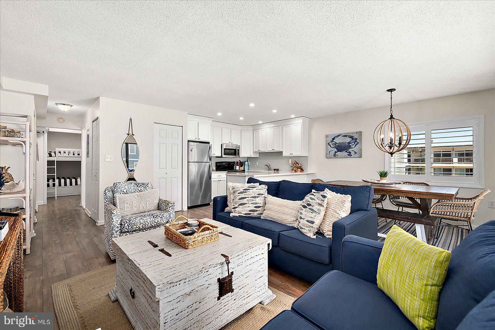 Welcome to Sand Dollar #203 - your perfect North Ocean City escape where coastal style and easy beach living come together effortlessly.  This  unit offers 1 bedroom plus den (den currently being utilized as a 2nd bedroom with bunk beds). This condo offers the ideal blend of comfort, design, and location, all just moments from the ocean. Located on the second floor, this inviting residence captures lovely ocean views while offering a sense of privacy and convenience. Inside, the space has been thoughtfully updated and tastefully decorated, creating a light, airy atmosphere that instantly makes you feel at home. The open living area is both stylish and functional, designed for relaxing after a day at the beach or gathering with friends and family. The kitchen and living spaces flow seamlessly, showcasing quality renovations and a cohesive coastal aesthetic that carries throughout the home. Two full bathrooms have been beautifully updated, offering a clean, modern feel with timeless finishes. Every detail of this condo, from the finishes to the furnishings, has been carefully considered, making it truly move-in ready and effortlessly enjoyable from day one. Set in a desirable North Ocean City location, you’re close to everything that makes beach living so special - restaurants, shops, and, of course, the shoreline just moments away. If you’ve been looking for a stylish, renovated condo with ocean views and a relaxed coastal vibe, Sand Dollar #203 delivers the lifestyle you’ve been dreaming of.