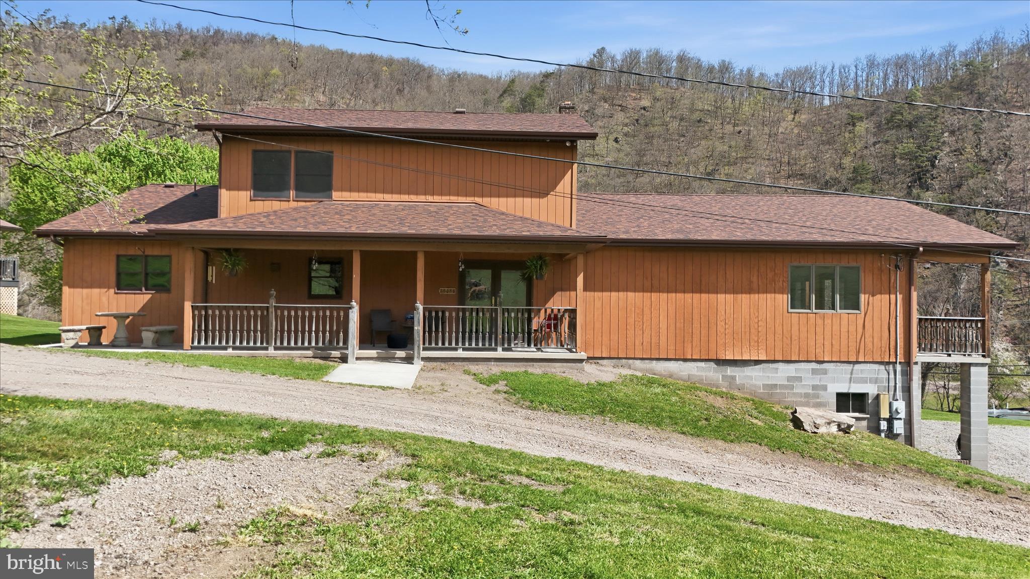 My oh my what a buy!! Turn off of Mount Savage Road where you are greeted by the Jennings Run stream that flows underneath the state-maintained bridge. Yes, the bridge is maintained by the state!! Proceed up the driveway and onto the wraparound driveway to access the vertical wooden siding house that awaits you and the 103 acres that provide enough space for the most creative of imaginations!! This property is located minutes from Interstate 68 and would be perfect for farming, access the stocked Jennings Run stream for great fishing, plenty of room for hunting, and plenty of timber. The Brush Tunnel on the GAP Trail and Western Maryland Scenic Railroad have a right of way that tunnels through the property. The pavilion on the property has been approved by the county as an additional building site, or could be utilized as another barn, additional living space etc. If you are not interested in just owning a parcel of land, you are in luck! This property also boasts a beautiful home. As you enter this 4-bedroom, two bathroom home, you will immediately notice the custom-built oak cabinets complimented with glass doors that allow the ability to showcase that fine China, family heirlooms, or whatever else the lucky homeowner would like to bring attention to! The large kitchen provides plenty of space for family gatherings. Interested in one level living? One bedroom can be found on the main level that would eliminate the need to utilize the stairs on a frequent basis. There is also a former half bath on the first floor that could be revitalized!! The house also boasts a very large living room, dining room, all-purpose room? You have to see the size of this room to believe it!! The beautiful hardwood floors and huge space provide a great opportunity to host holidays, family gatherings, or other events. The sky is the limit!! Covered porches practically surround this house that provide views of the farm or the mountainous landscape from the front porch. New carpeting can be found throughout the first and second floors with large bedrooms upstairs. The wraparound driveway provides ease of access to the house with two basement garage spaces that can protect a vehicle from the elements or house those fun seasonal toys. With the included acreage, snowmobiles, side-by-sides, or four-wheelers would allow you to roam the expansive fields. The roof is also less than 5 years old!! This property has so many features that make it a compelling combination of tranquility and opportunity! Schedule your appointment today and let your imagination see what's possible!!!