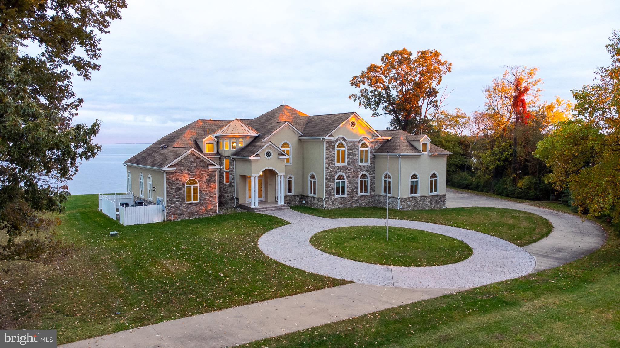 Welcome to your private river getaway!  This stunning, custom built home sits on 3 + acres with over 900 feet of waterfront, located on a point along the Potomac river, offering breathtaking views of the sun rising over the water.  Every detail of this home was carefully thought out while it was being built.  There is intricate, custom tile work in every single bathroom and throughout the home, including the expansive outdoor shower.  There are concrete steps at the shoreline that take you down to your very own sandy beach, where you can relax or go for a swim.  There is also a shaded boardwalk through the trees down to your pier, where you will find your private boat lift and  jet ski lift.  When you're done enjoying the river,  you can kick back and enjoy a drink at your private bar or balcony located on the second floor, while continuing to enjoy your river views.  Then you can take the elevator down to the main floor and cozy up next to the fireplace, either in the family room or the primary bedroom.  This property is exquisite! Schedule your private tour today to appreciate this home in person. In the meanwhile, be sure to check out the showing tour video, virtual tour AND the photographs!