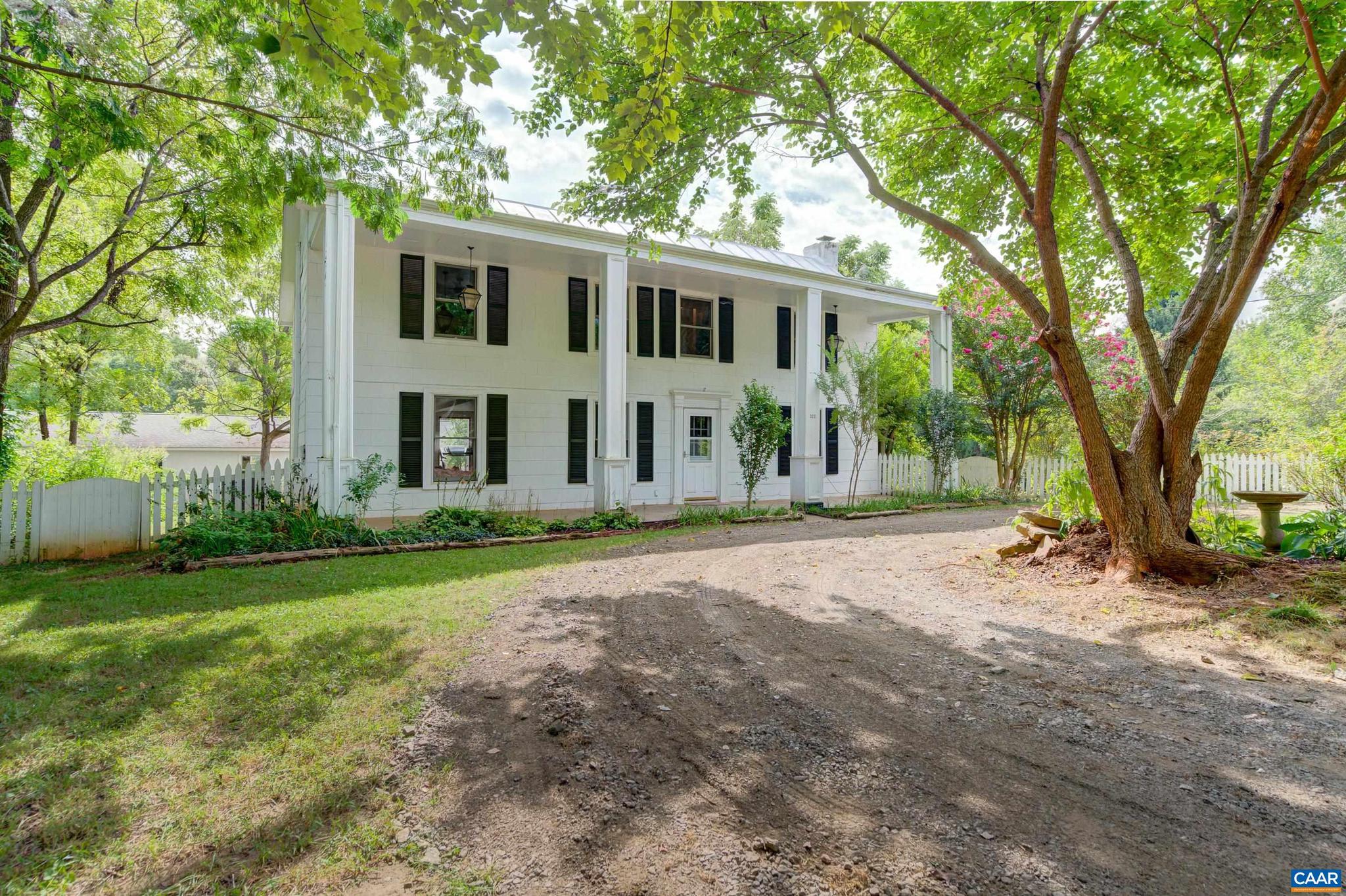 Nestled on 9+ private acres in Ruckersville, this charming farmhouse, built in 1890, offers a serene escape just minutes from town. Nature enthusiasts will revel in the wooded property's trails and bubbling stream. The interior boasts the character of heart of pine and hardwood floors, lovingly maintained throughout. A versatile flex room, perfect for a home office or playroom, welcomes you. The formal dining room, adorned with a modern farmhouse light fixture and wood stove, leads to a light-filled living room with a newly painted accent wall. The farmhouse kitchen, updated with quartz countertops, painted cabinets, and stainless steel appliances, offers a delightful breakfast bar. A renovated main-level bathroom features all new hardware and LVT flooring. Ascending to the upper level, the primary bedroom beckons with a private balcony and built-in closets. Three additional bedrooms showcase hardwood floors. The renovated full bathroom features a tub/shower combo with new surround and a vanity with an engineered stone top.  A detached ADU and new 10? x 20? storage shed, provide ample space for expansion and creative pursuits.,Painted Cabinets,Quartz Counter,White Cabinets,Fireplace in Dining Room