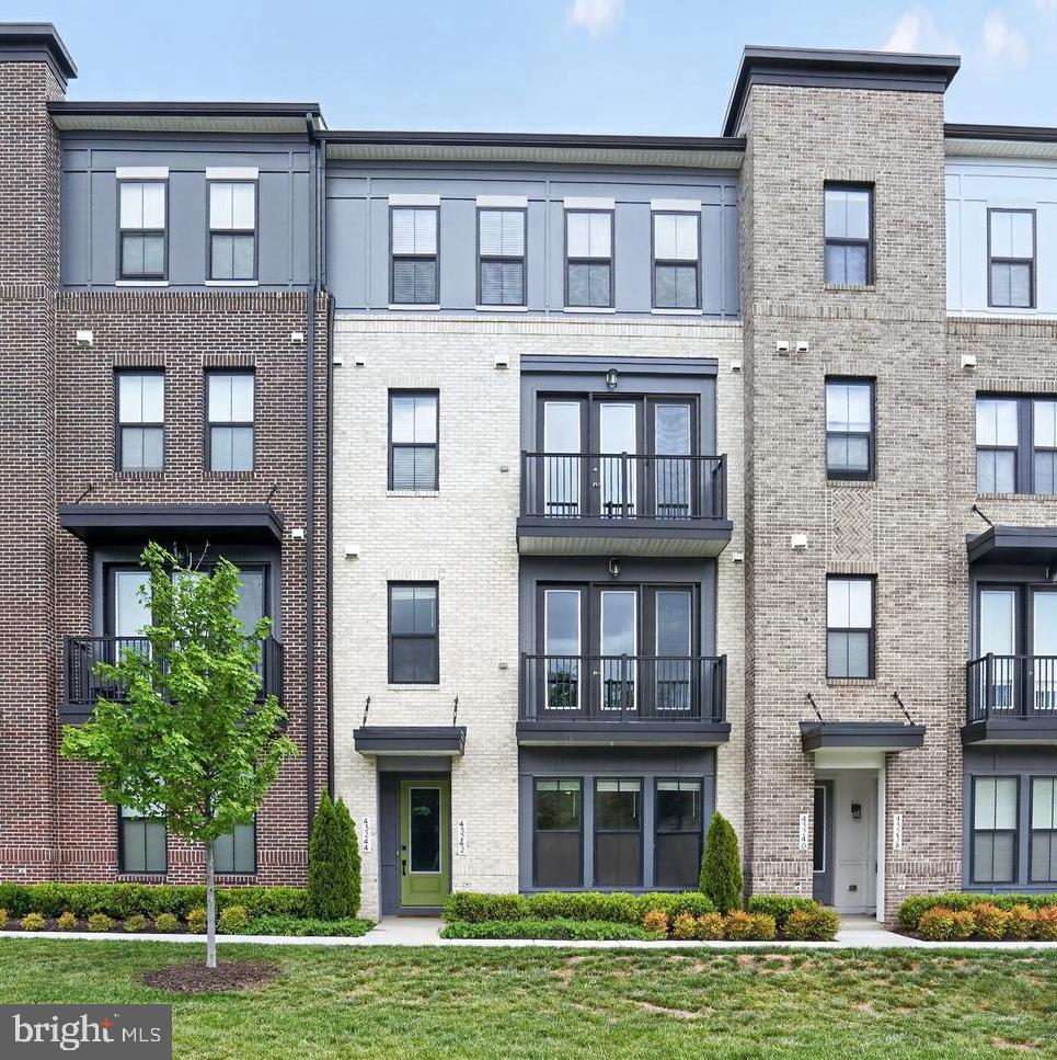 Excellent 4-level townhome-style condo located in the highly desirable DEMOTT & SILVER community, offering 3 bedrooms, 2 full baths, and 2 half baths. This beautifully designed residence showcases modern living with abundant natural light, high-end finishes, and thoughtfully curated designer selections throughout.

The entry level features a spacious garage, welcoming foyer, and a versatile recreation/office room along with a convenient powder room—ideal for work-from-home flexibility or additional living space. The second level offers an open-concept great room layout, seamlessly connecting the gourmet kitchen, dining area, and living space, along with an additional powder room, perfect for entertaining.

The third level is dedicated to the luxurious primary suite with PRIVATE BALCONY, complete with a spa-inspired bathroom featuring dual vanities, a separate shower, and a soaking tub. The top level includes two additional bedrooms and a full bath, providing flexible options for children’s rooms, guest suites, offices, or den space.

Living in Broadlands area offers an exceptional lifestyle with access to a clubhouse, fitness center, three pools, tennis courts, basketball courts, and an extensive network of walking trails. Everyday convenience is unmatched with nearby shopping centers featuring Harris Teeter, restaurants, cafes, banks, and gas stations and Ideally situated with quick access to I-267, US-28 routes and just about a mile from the Silver Line Metro.  

The seller is willing to offer a reasonable credit toward flooring replacement with an acceptable offer.