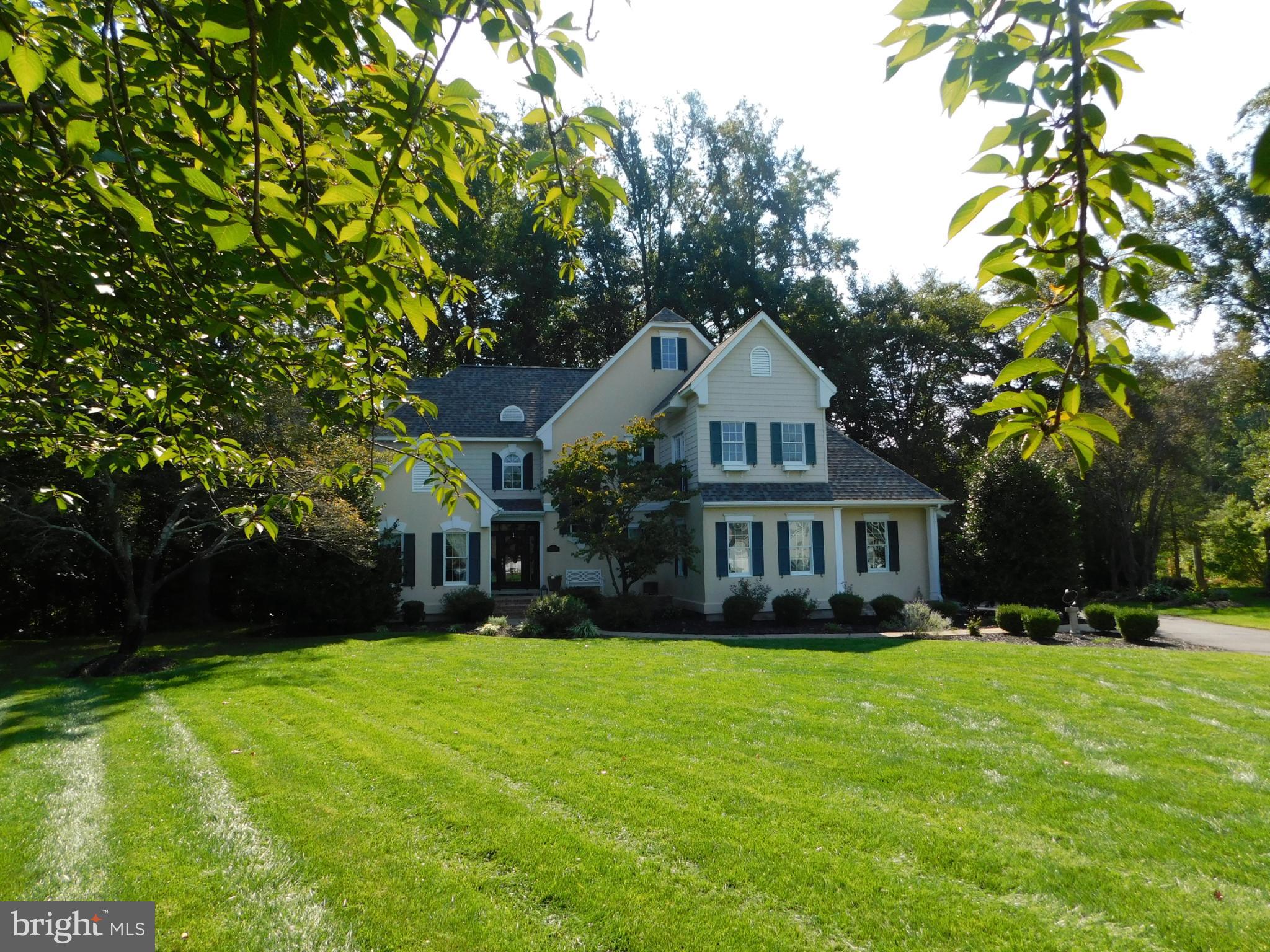 New Spring Market!  New Spring improved price!  This thoughtfully designed floor plan easily accommodates an in-law suite, whether located upstairs with adjoining rooms or on the main level. Just let your imagination run and the possibilities are endless.  In addition, the home features a fully finished walkout basement, offering exceptional flexibility. Welcome to this beautiful custom designed and built residence by Wilbur Smith, quietly nestled at the end of a cul-de-sac and backing to trees and wildlife in a peaceful neighborhood of approximately 18 homes. Opportunities to own a home in this exclusive community are rare, making this offering truly special.
Upon entering, you are immediately struck by the attention to detail evident throughout the home’s design and construction. The foyer opens to a spacious formal dining room featuring a cathedral ceiling, hardwood floors, and a dramatic floor-to-ceiling bay window. Beyond, the gourmet kitchen is equipped with everything one could desire, including a center island with cooktop and downdraft, double sink, custom cabinetry, and a separate serving area with bar sink for additional storage and functionality. A built-in desk area adds further convenience. The breakfast nook, surrounded by windows, offers lovely views of the private wooded backyard and patio.
The living room impresses with its soaring two-story ceiling, dual-sided fireplace, and custom built-in cabinetry designed to house entertainment equipment, with speakers wired throughout the first floor and patio. Elegant columns frame the upper level, adding architectural interest. Just down the hall, you’ll find a stylish half bath and a generously sized laundry room with built-ins, granite countertops, front-load washer and dryer, and even a concealed ironing board.
The primary suite is a true retreat, featuring a floor-to-ceiling fireplace, expansive window wall with sitting area, and a luxurious ensuite bath complete with heated floors, a large walk-in shower, a separate water closet, and an impressive walk-in closet tucked privately away. Ascending the turned staircase to the upper level, a bridge leads to a spacious guest suite with private bath and walk-in closet. Nearby is a large home office and a bright, oversized playroom—every childhood dream—which may also serve as an additional bedroom, or combined with the connecting bedroom and bath to make an in-law-suite on the second floor. The hallway continues to another bedroom showcasing custom woodwork, decorative moldings, and a charming window seat, as well as an additional bedroom on this level.
The finished basement provides versatile spaces for exercise, hobbies, and even a mirrored dance studio. Entertaining is effortless in this open, flowing layout. Step outside onto the private patio veranda and take in the tranquility of the setting. This expansive hardscape features a built-in grill and ample room for gatherings, from lively celebrations to intimate dinners. Relaxation and serenity await just beyond your door.
The architectural roof has been recently replaced. Don’t miss the opportunity to own this distinctive home in an equally distinctive setting. Your storybook home awaits  
View the floorplan and virtual tour of the home at this link https://www.homes.com/property/28-baltray-road-dover-de/kdl1l8bldtrc4/
