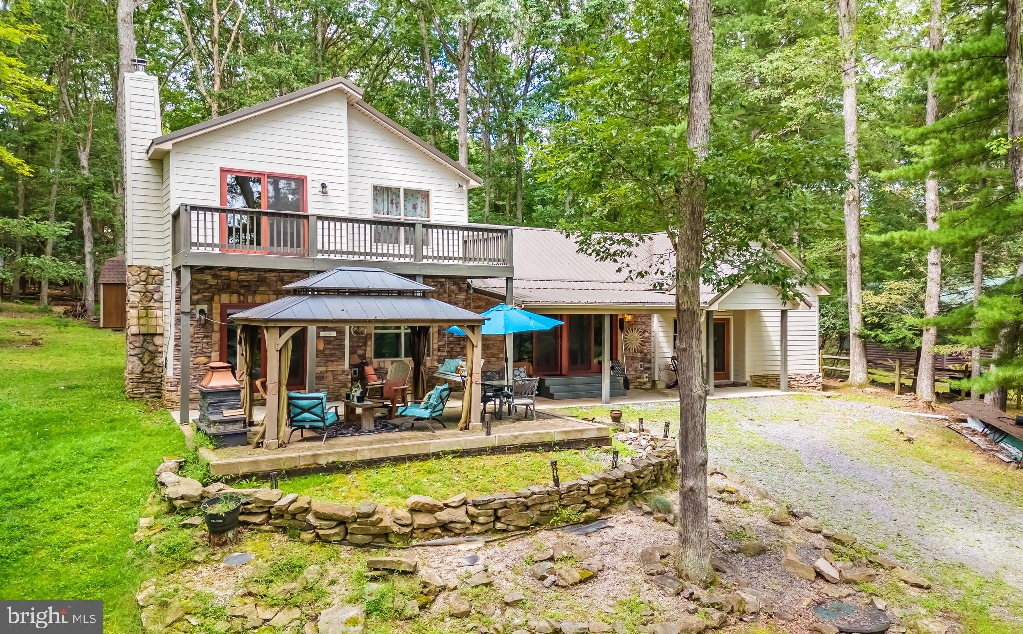 Uncover the charm and rustic elegance of this lake access retreat, nestled in the serene area of Beckmans Peninsula. This barely used contemporary cottage sits up high on a dead-end road with seasonal, filtered lake views. The 20’ of lakefront and Type A dock across the street is shared with the neighbor and provides great access to Deep Creek Lake in a wonderful cove. Boasting a beautiful kitchen with poured concrete countertops, luxury vinyl flooring, two fireplaces and a great loft area. The open floorplan is ideal for entertaining family and friends. The exterior area is very well thought out, offering two covered decks, a hot tub, and a gazebo. With .72 acres and two lots, there is ample space for kids and pets to play outdoors. The location is also just 3 miles to the DCL State Park, and 10 minutes to Wisp Ski Resort. Call today to preview this great home!