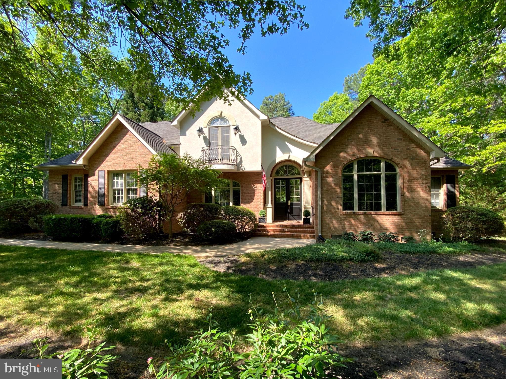 Located inside the luxurious gated Fawn Lake Community, this Gorgeous French Country Residence captures timeless elegance and grandeur from every angle. 
Built by the renowned Sandy Sagun, this custom solid brick Dream Home with a gorgeous exterior facade, complete with a Juliet Balcony and a stunning front door  features a sunlight interior graced with timeless architectural details, solid Oak hardwood floors, rich mouldings, archways, built-ins, and artfully curated living spaces filled with abundant comforts and beautiful design elements throughout.  Offering a beautiful and flowing floor plan with a desirable main level Owner's Suite and charming spaces for elegant yet casual everyday living and entertaining.    
Exuding curb appeal, this Residence is perfectly nestled on a .68 Acre lot filled with lush landscaping and an array of flowering shrubs and the most beautiful flowering trees highlighting the exterior of the property. Sited in a very desirable established area, along a scenic Cherry tree-lined sidewalk, just a stroll to the pool, beach, tennis courts, driving range, and the Fawn Lake Country Club Restaurants! 

Stepping through the custom double front doors, an elegant two-story Foyer with stunning archways and diamond pattern black and white marble floors welcomes you, and sets the tone from the moment you enter.   An elegant Dining Room with tray ceiling and stately columns offers the perfect setting for formal gatherings. The beautiful Den with vaulted ceilings features custom-built Bookcases and tall Palladium windows, inviting brilliant sunlight.  
The spacious Family Room features a stunning Fireplace anchored by built-in media cabinetry, and a wall of windows and French doors leading to the deck and peaceful backyard.
The Gourmet Kitchen with Maple cabinetry, and a center butcher top island offers plenty of space to prepare and cook meals. The cozy Breakfast nook with large windows offering views of the backyard, features French doors leading to the Screened Porch and the rear deck. 
A true sanctuary, the expansive Primary Suite features two walk-in closets, a spa bath with double vanities, tile shower and a soaking tub for relaxing. 
The upper level includes Three gracious Bedrooms with large windows, walk-in closets, and a shared Full Bath with dual sinks. 
With unlimited possibilities, the unfinished Basement offers an additional 1,500 SQ FT of space for storage and future expansion!
The backyard sanctuary offers an idyllic space for extended outdoor living and entertaining, a screened porch and spacious deck with with a wisteria covered arbor are ideal for alfresco dining, lounging, and taking in the sights and sounds of nature. 
An oversized 2-Car Garage and extended driveway provide ample parking. Recent updates include:  Water Heater, Sump Pump, washer and Dryer - 2019. HVAC - 2014 . Live with ease in this well appointed and thoughtfully designed architectural gem that fuses luxury and sophistication with tranquil living.  
Come experience what the Fawn Lake lifestyle is all about where every day is a vacation! 
The luxury and vibrant Fawn Lake Community offers amazing amenities such as a boating recreational lake, sandy beach, an Arnold Palmer Golf Course, pickleball and tennis courts, baseball and soccer fields, dog park, volleyball courts, walking trails, Community ClubHouse, marina, fitness center, restaurants, Country Club, playgrounds, and more!  With an array of clubs, groups and daily activities, you will have plenty of opportunities to join the social scene, make new friends and remain active! Located in the countryside near the town of Fredericksburg, surrounded by park lands and only a few miles to the farm market, wineries, and award winning breweries! Conveniently located to shopping, restaurants  and top-rated Riverbend District schools and I-95!