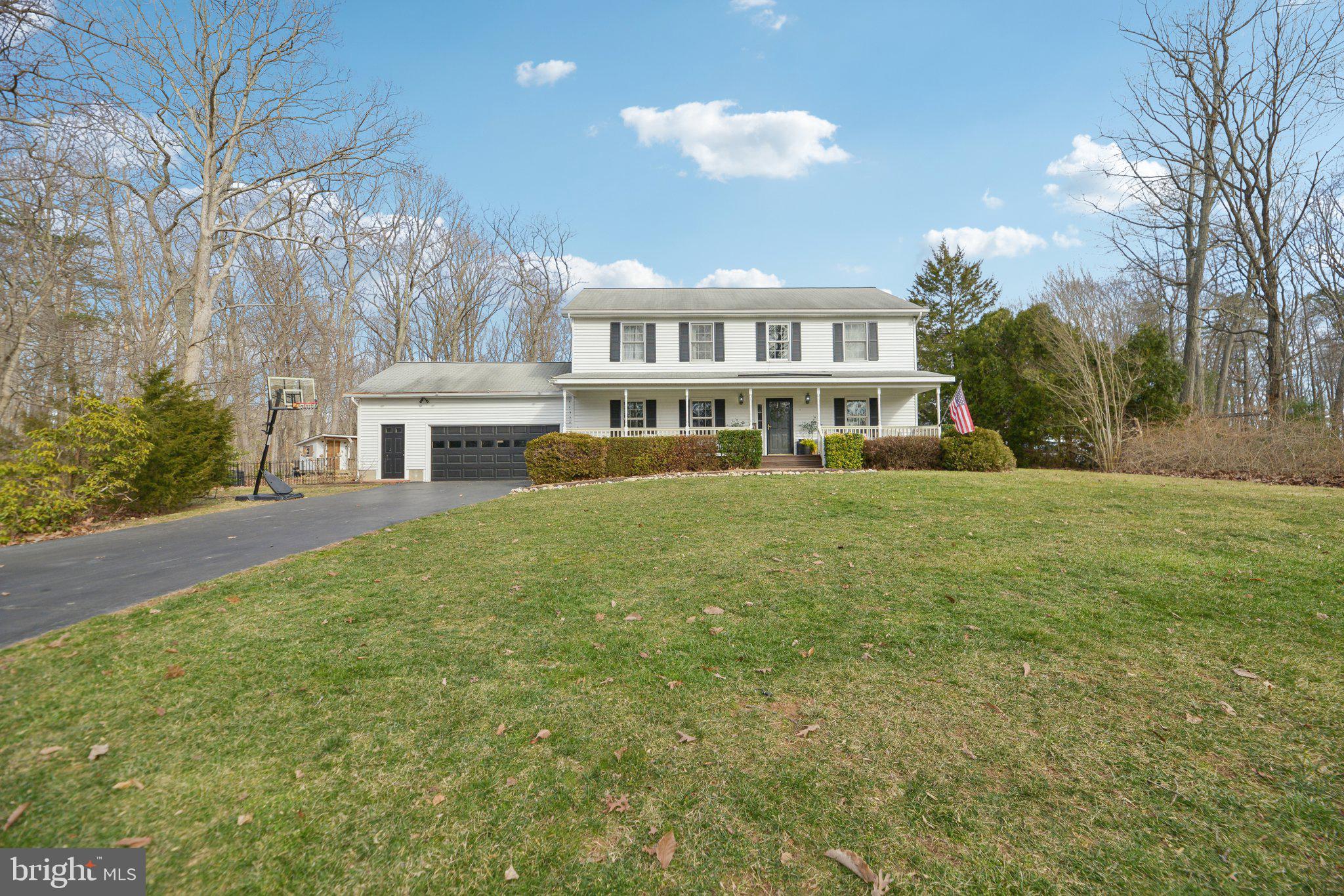 Impressive Colonial Home in the Quiet Bren Forest Community with Top-Rated Schools

Located in the peaceful and sought-after Bren Forest community, this exceptional colonial home offers not only serene surroundings but also the trifecta of excellent schools: Colgan High School, Benton Middle School, and Marshall Elementary. Surrounded by vibrant landscaping, flowering shrubs, and tranquil woods, this home provides a private retreat with a large deck, a charming playhouse, and a stone patio, new fence in 2022, ideal for outdoor entertaining or quiet relaxation. The expansive front porch is the perfect place to watch local wildlife, including deer, as they roam the area.

Inside, the home features stunning hardwood floors throughout the main and upper levels, with durable vinyl flooring in the lower level and hardwood in the kitchen and breakfast nook. Key updates include a new roof in 2009, an upgraded HVAC system in 2013, air handler 2024, and a new well pump in 2017. The septic tank was pumped in 2020, well tank upgraded to 30 gallons in 2024, and the septic field is approved for four bedrooms.

The spacious front-loading garage is built with an extra 6 feet of width and has direct access to the finished basement. A bright and airy sunroom, with 17 double-pane windows and 4 skylights, offers the perfect space to entertain while enjoying views of the gardens and woods. The home is equipped with double-pane windows throughout, featuring attractive wooden sash frames.

The renovated gourmet kitchen features  “soft-close” cabinets and drawers, complemented by sleek quartz  countertops. The adjacent half bath conveniently houses the laundry area, and the washer and dryer are included. The main-level bedroom, with a large closet, could also be used as an office or den.

Upstairs, the spacious primary bedroom boasts hardwood floors and an en-suite bathroom with a stall shower, walk-in closet, and a large cedar closet. Two additional generously sized bedrooms with stunning hardwood floors share a full hall bathroom with a tub and shower combination.

The finished basement offers additional living space with a large recreation room, a workshop, and a storage room, plus stairs leading directly to the garage.

This beautiful home is the perfect combination of indoor and outdoor living, complemented by its prime location within the top-rated school district. Don’t miss out on the opportunity to make this exceptional property your own!
