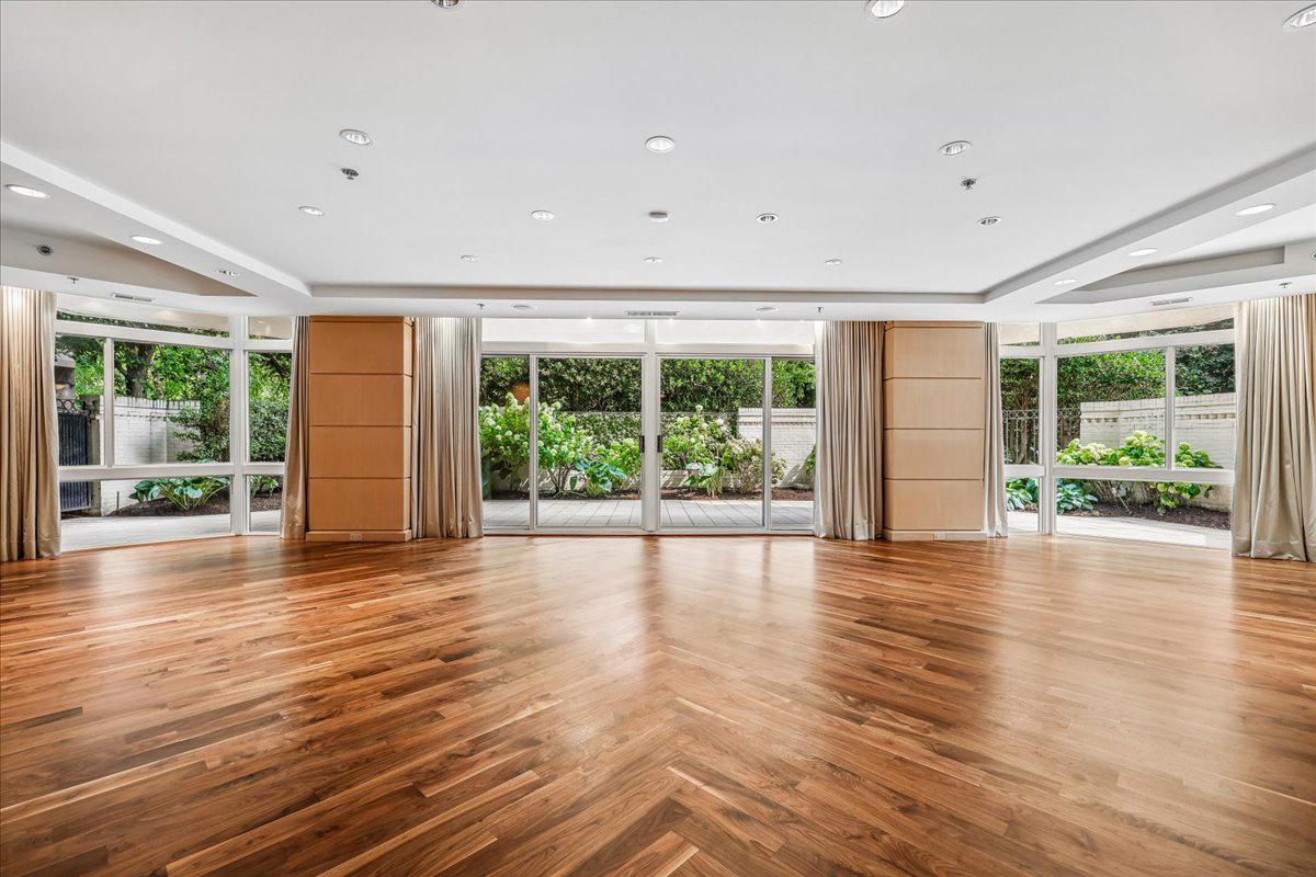 Welcome to this rare, bright main-level 3,000 sq ft condo featuring 2 bedrooms plus a den (or 3rd bedroom), 2.5 baths, an oversized private terrace plus a balcony off of the primary bedroom. Step inside the grand foyer entry with coat closet and a formal powder room.  The oversized living room has multiple sliders leading to your own private sprawling pavered terrace and gardens. Separate laundry closet and entry into the large gourmet kitchen with ample cabinetry and large island. The separate formal dining room features custom built-in cabinetry. Off of the living room is the library/den (or 3rd bedroom) with 2nd access door from the hallway.  The primary bedroom suite includes a dressing area, a large walk-in closet, an oversized bedroom chamber with a sitting room and extra custom built-ins, and an en-suite primary bath with shower, commode closet and a walk-in closet. The second bedroom has a walk-in closet and its own brand new ensuite full bath (with access door to the den/3rd bedroom . Beautiful refinished hardwood floors throughout and gorgeous custom wood panelled walls. 2-zone HVAC systems. 

Enjoy elegant, resort-style living in Friendship Heights’ most luxurious complex, set on more than 17 acres. This gated community offers a gatehouse, 24-hour security, beautifully landscaped grounds, and walking paths. Residents can use tennis courts and a three-story clubhouse with indoor and outdoor pools supervised by lifeguards, party rooms, a modern gym, racquetball, billiards, ping pong, and aerobics rooms. The amenities are truly endless. Plus, you’re just a short walk from shops, grocery stores, restaurants, and the Friendship Heights Metro station.