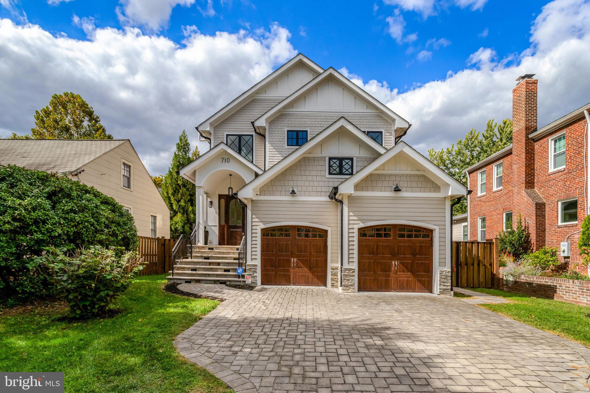 Located just 3 blocks from the Metro and across from Zitkala-Sa Park, this custom-built home offers over 5,000 square feet of beautifully designed living space. The open, contemporary floor plan feels inviting and bright, featuring 10-foot ceilings and wide-plank, hand-scraped light hardwood floors throughout the main and upper levels.

The gourmet kitchen, finished in timeless white tones, enhances the home’s airy feel and flows seamlessly into the eat-in area with a built-in window seat and custom dining table that seats twelve. The family room centers around a striking custom marble fireplace, providing a comfortable space for relaxation and entertaining. A dining alcove, private study, mudroom with custom built-ins, and powder room complete the main level.

Upstairs, the luxurious primary suite impresses with a cathedral ceiling, custom walk-in closet, and a stunning ensuite bath featuring a soaking tub, glass-enclosed shower, dual vanity, dedicated makeup counter, and private water closet. The upper level also includes two spacious bedrooms with a shared bath, a fourth bedroom with ensuite, and a conveniently located laundry room.

The lower level offers a fifth bedroom, full bath, fully outfitted gym with mirrored wall and glass door, and a large recreation room featuring a built-in wine wall and wet bar with microwave and storage. Double doors lead to a walk-up exit and the fenced rear yard.

Set on a .15-acre lot, the outdoor space includes a raised composite deck and a step-down to a flat, usable yard—perfect for entertaining or play.