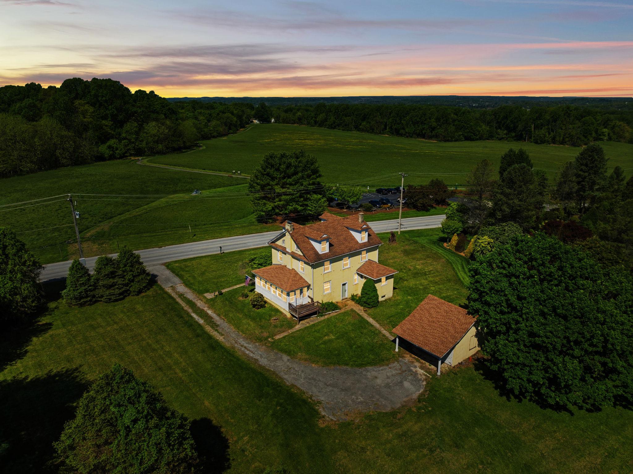 When listings talk about being a once in a lifetime opportunity to buy a historic and iconic home, they're usually exaggerating just a bit, but not this time. Nestled on top of the hill overlooking Sandy Hollow Heritage Park, 42 acres of open space with sweeping views of the countryside and located between historic Dilworthown and bustling West Chester stands the Charles Davis House. Built in 1926 and owned by just two families in 100 years. This stunning home is being offered for sale and it truly is a once-in-a-lifetime chance to make this house in the Unionville-Chadds Ford School District your home to cherish for years to come.

Walk up the front path through the graceful entrance columns and into the foyer which features a large coat closet by the stairs and doors into all the rooms on the first floor. To your right is the large living room with a wood burning fireplace, windows overlooking the park and the back yard and twin doors into the 3-season side porch. The porch is the same size as the living room and could easily be outfitted with splits for year-round use, with windows on 3 sides and a back entrance that goes to the side/back deck and then to the driveway.

Across the hallway from the living room and through the original French Doors with their antique key is a nice sized dining room with windows on 2 sides overlooking the park. As was common for this style of home, the kitchen is modestly sized and in the back of the home, it features vintage wood cabinets, enough space for a small table or island, and incredible views of the park from the window over the sink. 

Just off the kitchen is the laundry room with enough space for a stand-alone washer and dryer, and the large fridge, and the door to the downstairs full bath with shower. In the back of the house, off of the garage you have the back door which opens on to a landing where you can choose to walk down to the basement, or up a few steps into the kitchen. In addition to the laundry room upstairs, there's a massive double laundry or utility sink in the basement for washing large items and you could of course relocate the laundry back downstairs if desired. 

Up the original stars you have 4 nice size bedrooms, all of them have stunning views of the countryside with 3 having views of the park and the last one looking out over the local country road and backyard. Bedrooms all have original wood floors, doors and vintage light fixtures, one bedroom has double closets, the rest have a single closet. For the age of the home the closets are nicely sized and have more room than you might expect. 

The upstairs bathroom has a vintage iron / ceramic tub that is believed to be original to the house, the bathroom requires repairs and is not usable at this time. The house is being sold as-is with repairs in mind and with 1 full working bathroom with shower you could still live in the house while doing the work if desired. The bathroom is a nice size and you could either restore the tub and keep it or swap it out to something new.

Conveniently located on a country road you're still only minutes away from many major local travel routes with all of the shopping you'd expect and minutes to Delaware.

It's not often that you get the combination of a historic property, with sweeping protected views, good bones, original and period details that you can live in while restoring if desired. How many decades of sunrises and sunsets will you watch, how many generations of owners will call this place home and cherish the memories made here while enjoying the history of the local landscape. The home is located in the Historic District of Birmingham Township. Please refer to the township regulations for any applicable restrictions. Property is being sold as-is.