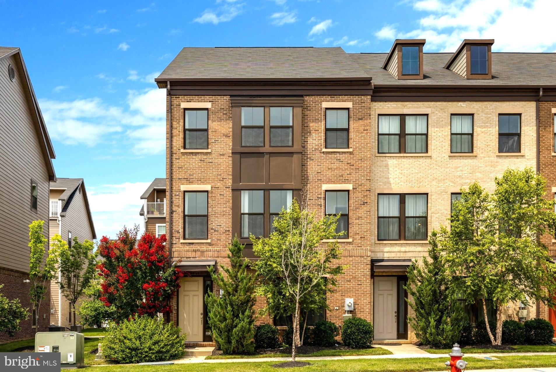 Stunning 4-level brick-front townhome , 2019 built, in Discovery Square features 4 bedrooms, a loft, 2-car garage, 3 full baths, and 2 half baths. The entire home is freshly painted, with brand-new luxury vinyl plank flooring installed in  bedrooms. The entry level includes a bedroom with a full bath, a mudroom, and a garage with newly finished Epoxy flooring. The main level boasts Hardwood floors, an open-concept layout, a Spacious Living Room with a fireplace, built-in bookcases, a formal dining area with accent wall, and a half bath. The Gourmet Island kitchen shines with a massive quartz island, gas cooktop, vent hood, wall oven, microwave, and pantry. The upper level offers a Spacious Primary suite with a walk-in closet, updated Master Bathroom with double sinks, Two additional bedrooms sharing a full bath, and a laundry room with a newer washer and dryer. The fourth-level loft features a half bath, closet, and access to a huge rooftop terrace. The heating unit has been recently replaced in the HVAC system. This community backs to Sully Highlands Park, the property is close to the new Sully Community Center, very short distance to Dulles Airport, Silver Line Metro, Reston Town Center, Route 28, and the Dulles Toll Road, shopping, restaurants. The subdivision has multiple courtyards, play area/tot lots, jog/walk path. Open House this Sunday between 1:00 PM to 3:00 PM.
