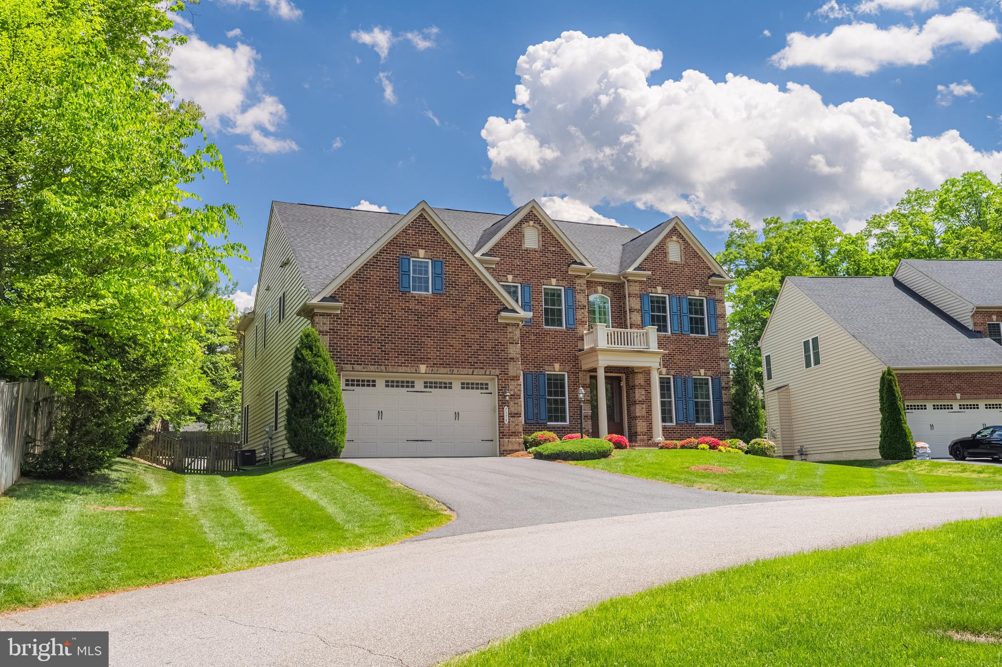 Exceptional Home in West Springfield’s Premier Enclave. Step into luxury with this extraordinary Chapel Hill II model, showcasing every builder upgrade and luxury enhancement imaginable. This exquisite five-bedroom, four-and-a-half-bath brick-front colonial is ideally situated on a quiet cul-de-sac and offers refined finishes, designer details, and one of the most breathtaking private backyards in the area.
A stately covered entry with custom double glass doors welcomes you into a grand foyer, where rich, walnut hardwood floors flow seamlessly throughout the main level. Designed to impress and built for comfort, the home features a dramatic two-story family room with a stunning stone fireplace, custom built-ins, and expansive windows that flood the space with natural light and offer sweeping views of the professionally landscaped backyard. The gourmet kitchen is a chef’s dream appointed with premium granite countertops, a massive breakfast island, top-tier stainless steel appliances, and a sunlit breakfast room that overlooks the serene rear grounds. The kitchen is outfitted with a premium refrigerator that features a spherical icemaker that is perfect for entertaining and making stylish craft cocktails.  Adjacent to the family room is a sophisticated main-level office with custom built-ins, perfect for remote work or study. Step outside to your own private resort-style retreat. Enjoy year-round entertaining on the covered lanai, complete with a gas fireplace and pre-wired for an outdoor television. The lower slate terrace features a gourmet outdoor kitchen appointed with high-end finishes, integrated refrigeration, built-in grill, and a generous counter space for elevated outdoor gatherings. The backyard is framed by elegant stone retaining walls, ornamental trees, a cozy fire pit, and a tall privacy fence, creating a serene and secluded oasis. The expansive owner’s suite is a true sanctuary, offering a spa-inspired bath with relaxing soaking tub, oversized dual-head shower, custom tile, dual comfort-height vanities, and two large walk-in closets—including one exceptionally spacious one with custom closet system. The suite also includes a private sitting area that opens to a tranquil balcony overlooking the beautifully landscaped grounds. Elegant dual staircases lead to the upper level, where you'll find three additional spacious bedrooms. Two share a Jack-and-Jill bathroom, while the third has its own en suite. A convenient upper-level laundry room with built-in cabinetry and ample storage completes the space. The fully finished lower level is designed for both entertainment and relaxation. It features a custom full bar with granite counters, refrigerator, dishwasher, and cabinetry, as well as a walk-in pantry with an additional fridge. A media-ready game room with surround sound, a fifth bedroom with full bath—ideal for guests—and a newly remodeled home gym with rubber flooring, floor to ceiling mirrors, and media hookups complete this incredible level. Ideally located just 5 miles from the Franconia-Springfield Metro and minutes to parks, trails, shopping, dining, and major commuter routes, this home effortlessly combines timeless sophistication with modern luxury. It’s truly one of Northern Virginia’s most remarkable residential offerings.
