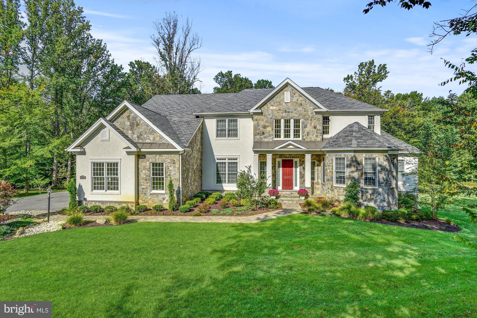 LUXURY LIVING CLOSE TO EVERYTHING! Enjoy a Dramatic 2-Story Foyer, gracious curved stairway, SPACIOUS formal LR & DR,  Family room w/ tall stone fireplace & coffered ceil, Conservatory, Study & ELEVATOR. LUX Master bedroom with sitting area and upscaled bath with soaking tub. ALL EN-SUITE BRs up!  Finished FULL-DAYLIGHT LOWER offers REC Rm, Exercise, STORAGE & walk-out. Paver patio, garden walls, deck &Gazebo back to trees on beautiful lot. Come home to indoor & outdoor comfort, convenience & LUXURY!