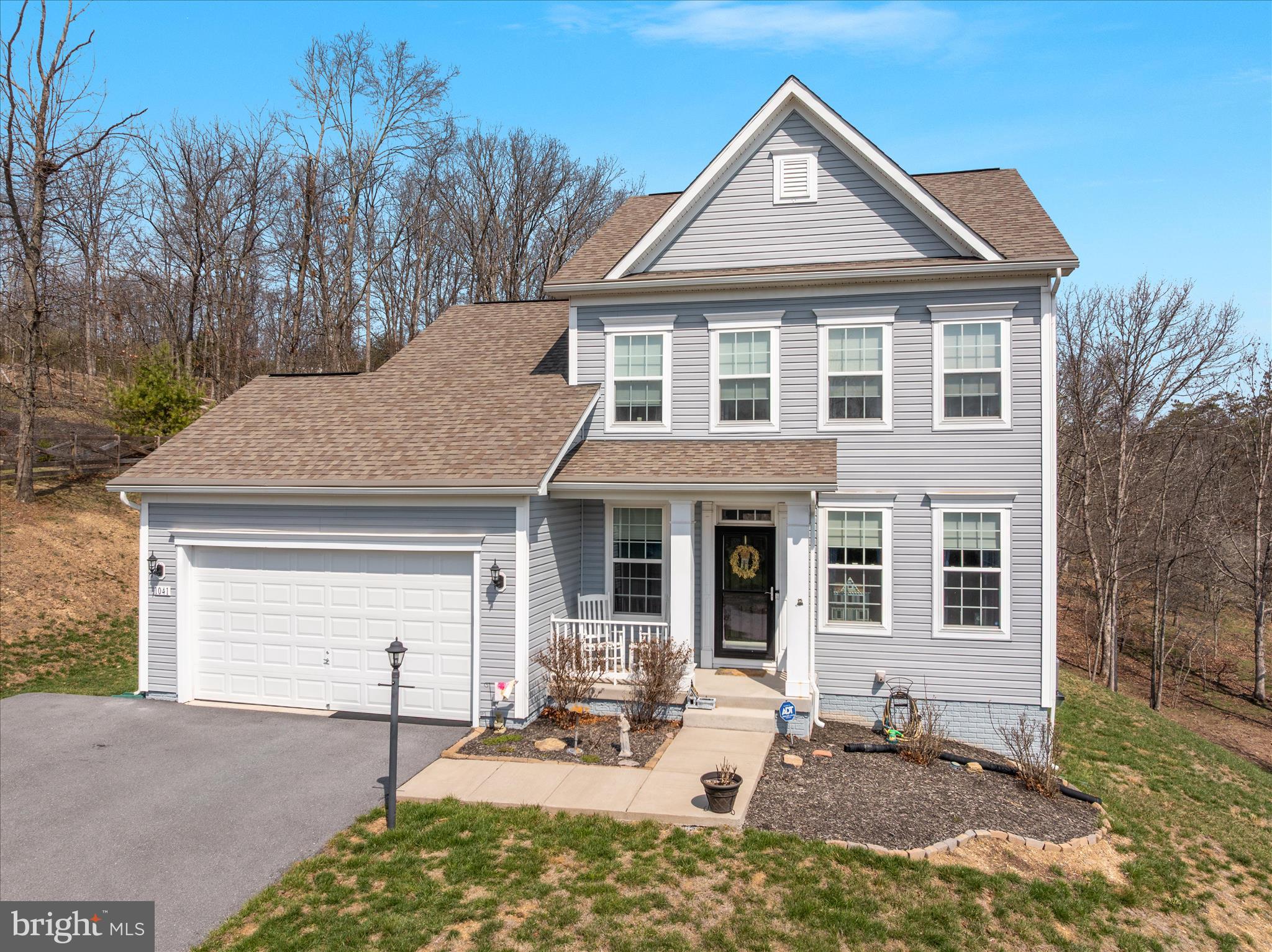 Beautiful one owner colonial featuring wood floors on the main level, and a basement with tons of room to grow! A formal dining room greets you, which can also be used as a study or office. The kitchen with lots of cabinets and an island is open to the vaulted living room with a cozy electric fireplace to warm yourself. There is room to add a deck off this level to enjoy your tree view in the back yard. Upstairs you'll find 3 bedrooms including a primary with en-suite, as well as the laundry. The basement offers plenty of space to add more living area, with a roughed in bathroom that already has drywall installed. You'll be just a one minute drive to beach 1 with the clubhouse, sports courts, marina, playground and more. Lake Holiday offers a ton of amenities from beaches, to a dog park, 18 hole disc golf course, all in a private gated community. Come vacation where you live!