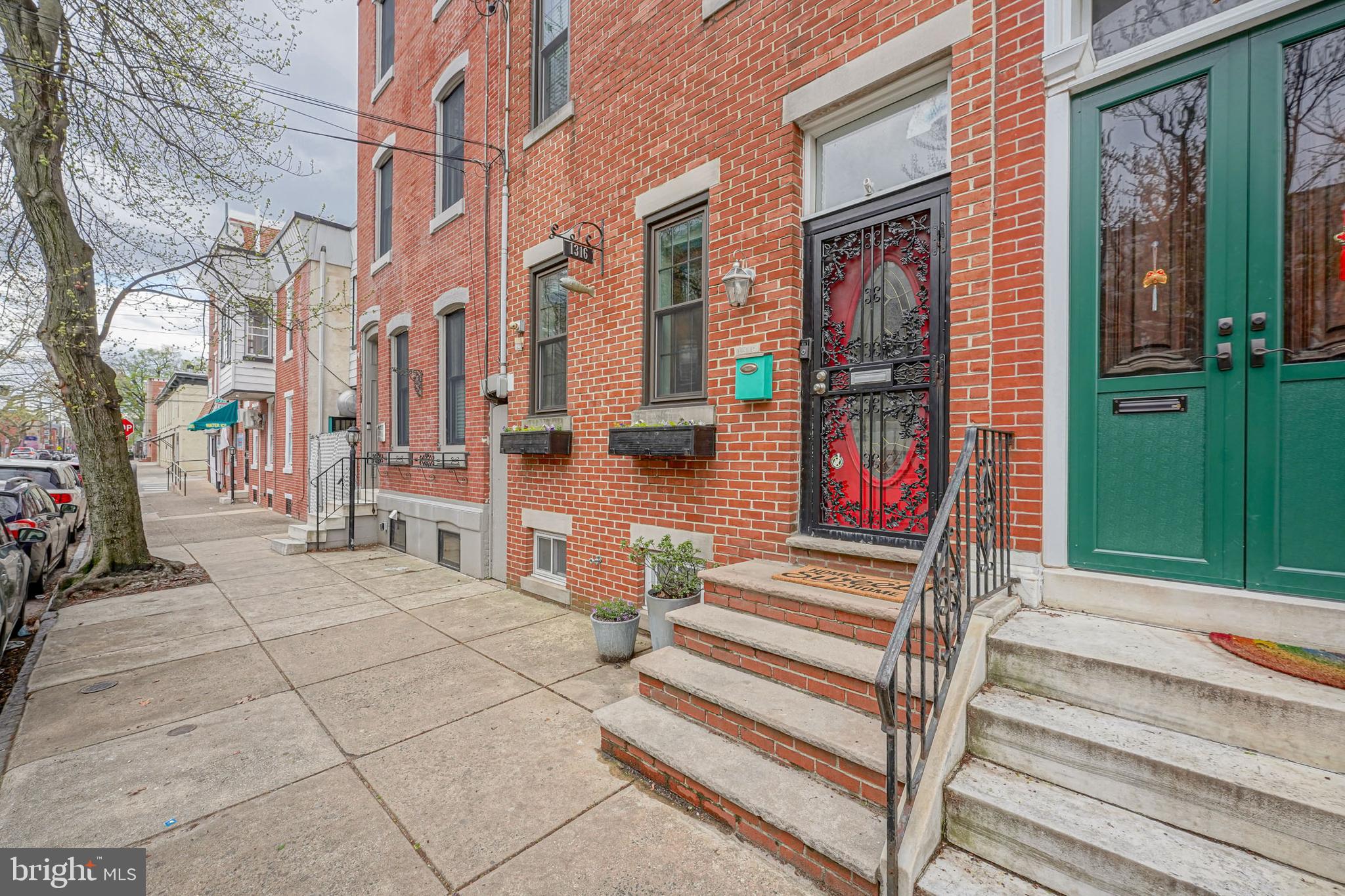 Have you been hoping for something special to hit the market!? Well this just might be it! Welcome to 1316 E Montgomery Ave!  Located on a gorgeous block in the heart of Fishtown featuring 4 full bedrooms, 2 full bathrooms and 2 half bathrooms. This is a large and almost 2,000 square feet, beautiful home. When you step into this home, you will immediately notice the large living room with high ceilings and very nice hardwood floors. These scraped butcher block real hardwood floors run the length of the living room and dining room. If you take your shoes off, you will notice that they have such a comfy feel when walking on them. The open living room and dining room is spacious. Off to the side you will find the first powder room conveniently located on the first floor. Then flowing right into the kitchen area and you will start to feel the wow factor. The kitchen is so exquisite, delightful, and bright! Beautiful color combinations of grey and white. Quartz counters, subway tile backsplash, lots of cabinet space and plenty of workspace here. There is a counter that hangs into the dining room so that you can set up stools. Entertaining  with your guests in this kitchen will be quintessential.  There is room for everything you need. Lets also mention the beautifully done ceiling with a full size ceiling fan that is another excellent feature. At the end of the kitchen, you will find sliding glass doors to go out to the perfect size backyard! Just the right amount of space to really enjoy time with family and friends outside. Its super nice and it includes an apple tree! On to the 2nd floor, there is a large back bedroom featuring bamboo floors. Then located on the 2nd floor hall is the laundry room which holds a full size washer and dryer. The front bedroom is the main bedroom which features the same hardwood floors as the downstairs and a large En Suite bathroom. Some recent improvements were just made to this bathroom including the installation of a larger shower and a very large vanity/cabinet and new tile floors. The jacuzzi tub is the perfect ingredient when you need a Me day. Then we go upstairs again to the third floor. You will find 2 more sizable  bedrooms with carpeting and nice ceiling fans. On this 3rd Floor is the 2nd half bathroom. You will notice a door that goes to the outside roof. There used to be a roof deck here but the owners had to remove it in order to replace the roof below. The entrance door and location is all set and ready if you decide to install a new roof deck. The next amazing thing to mention is the basement. The basement is finished and a wonderful additional space to this already large home. It is clean, comfy, and cozy! Nice carpeting and lighting. Lots of room for the fun you are thinking of! And there is also a small storage area at the other end of the basement that could be used  as an area for work or play.  The basement was professionally waterproofed with French drains and a sump pump. High efficiency Lenox brand heater and central air. The 3rd Floor bedrooms have additional Carrier Brand air conditioning units to make sure these rooms stay cool in the summer. Almost all of the windows have been replaced in recent years.  Home is also located in the Adaire School area but please make sure to independently verify all schools related information that you need to know.  Wow just wow.  A truly magnificent home.