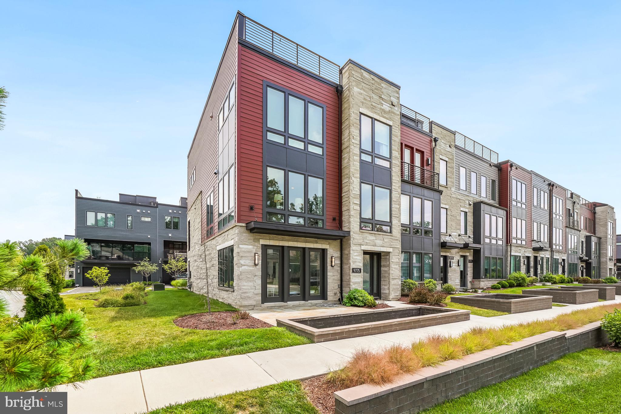 Welcome to 9775 Sanvalita Street, an almost-new luxury end-unit townhome in the prestigious Amalyn community. Offering over 3,000 square feet on three light-filled levels, this exceptional home features 4 bedrooms, including a main-level bedroom, 3.5 baths, and expansive walls of windows that fill the home with natural light while providing exceptional privacy. The gourmet kitchen opens to the living and dining areas and a covered outdoor terrace, perfect for relaxing or entertaining. The luxurious primary suite includes two walk-in closets with custom organizers and a spa-inspired bath.
Enjoy Amalyn's resort-style amenities, including a clubhouse, outdoor pool and splash pad, fitness center, Zen garden, pocket parks, playground, and scenic walking trails. Ideally located just minutes from Balducci's, Montgomery Mall, NIH, Walter Reed, downtown Bethesda, Metro, and major commuter routes. Zoned for Ashburton Elementary, North Bethesda Middle, and Walter Johnson High School.