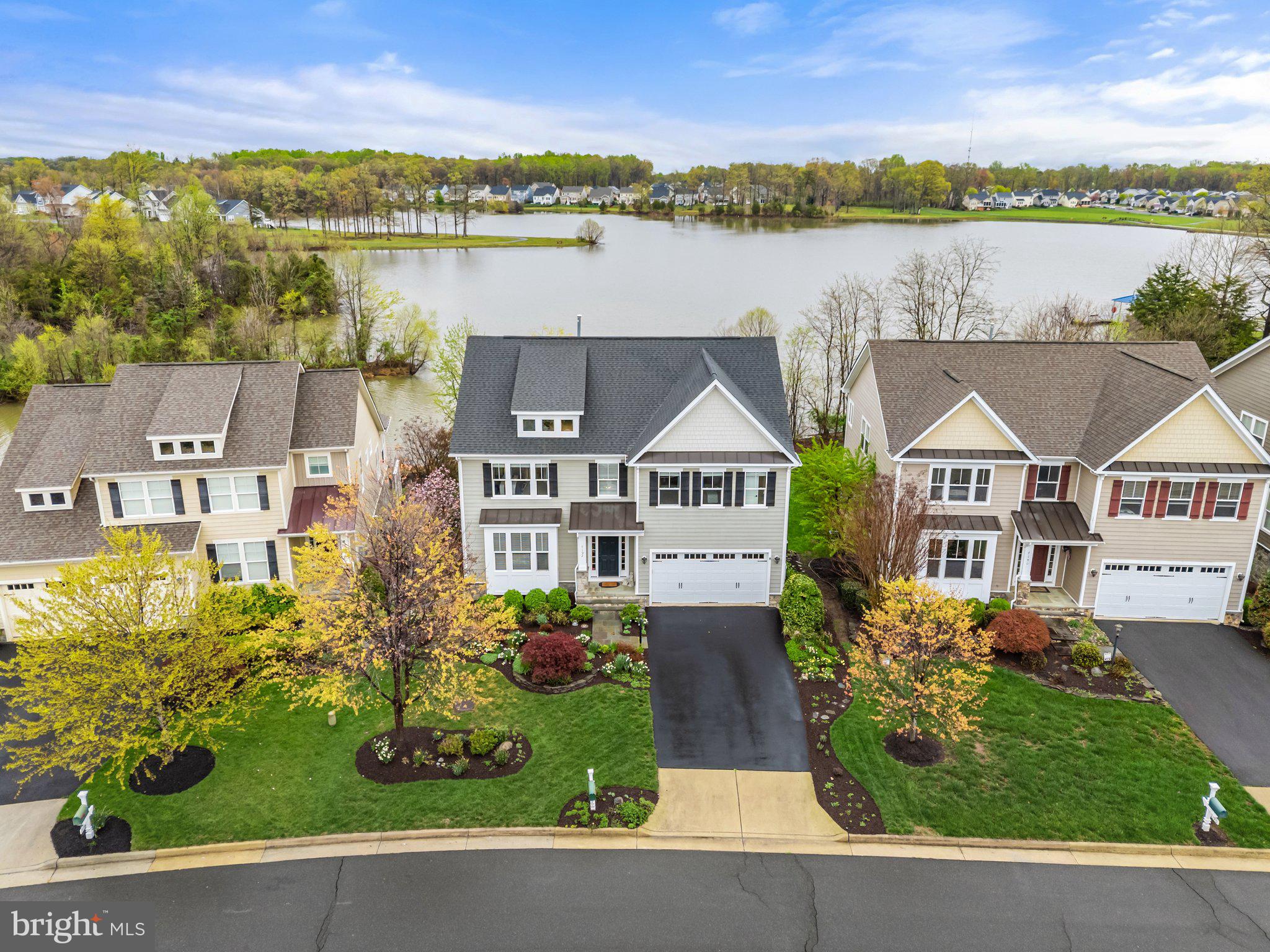 Wow, what a view from the moment you enter this home!!!  This lakefront home built by Lakeside Homes leaves nothing to be desired!  Gourmet kitchen with all KitchenAid appliances, large granite island with prep sink, stone fireplace, 5” hickory hardwood on the main floor, Hardie plank siding with stone foundation, and much more.  Lower level features  walkout to covered flagstone patio and 9' ceilings to keep the home feeling open and bright with natural light. Enjoy your lake view from the sunroom, screened porch, deck, and covered patio, even from the primary bedroom. No backyard neighbors except for the eagles, herons, turtles, swans, egrets, etc. Mature and extensive low maintenance landscaping with sprinkler system gives the home special curb appeal. Well-kept outside and in, this home is ready for its new owners to get cozy or to entertain. Enjoy all Brookside has to offer in views, amenities and location. In addition you'll be within walking distance to the pools, club house and exercise rooms!