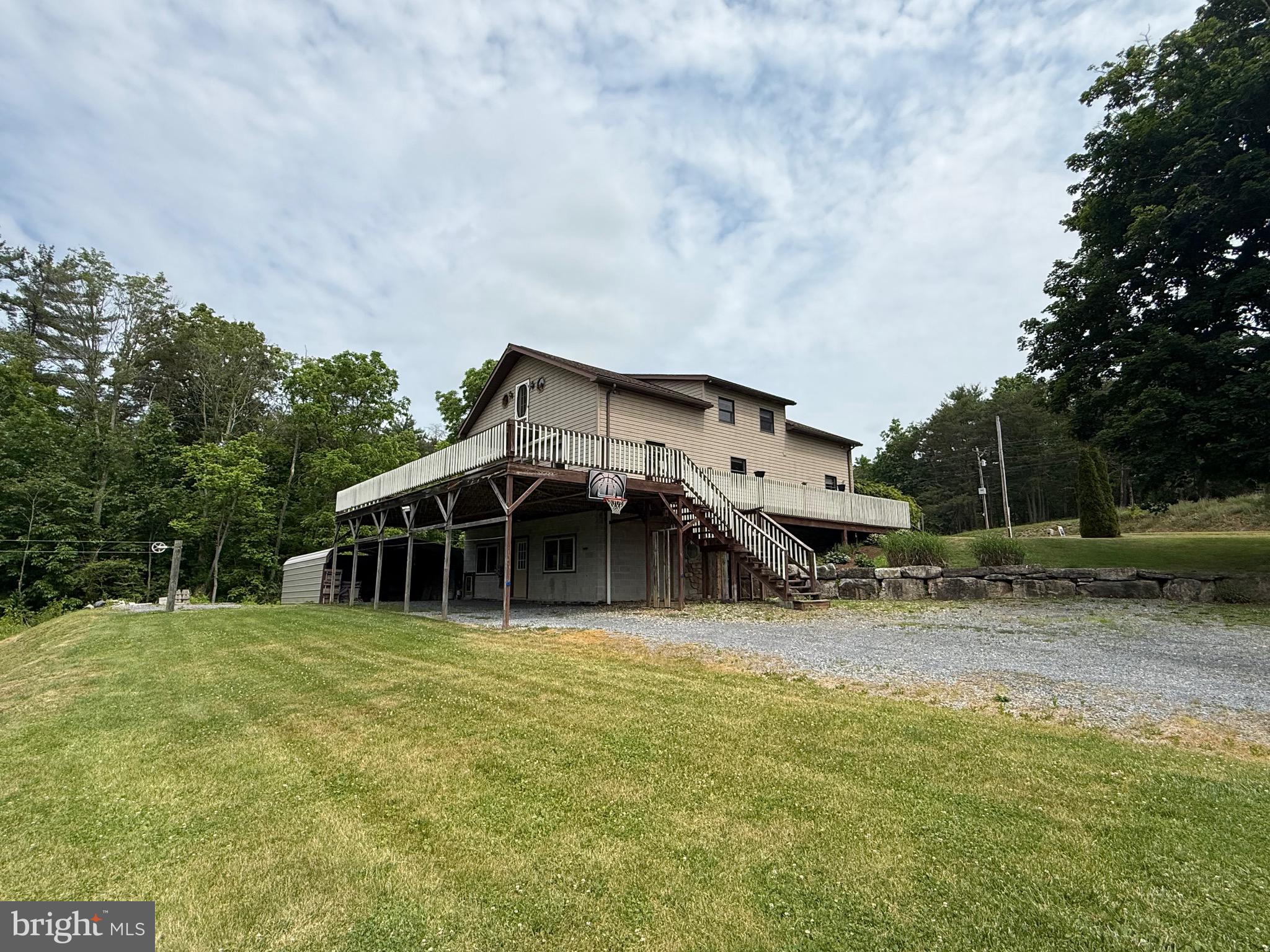 This incredible, move-in ready home has been impeccably maintained and offers a peaceful, wooded backdrop. Enjoy morning coffee on the deck while taking in the surrounding scenery. The spacious primary suite features a generous walk-in closet and an en-suite 3/4 bathroom complete with a jetted tub. Main-level bedrooms are connected by a full Jack-and-Jill bathroom, providing both convenience and functionality. Cozy evenings await in the living room, with a woodstove hookup available. The private backyard and deck are perfect for family gatherings and summer barbecues. This home is truly move-in ready—schedule your showing today.