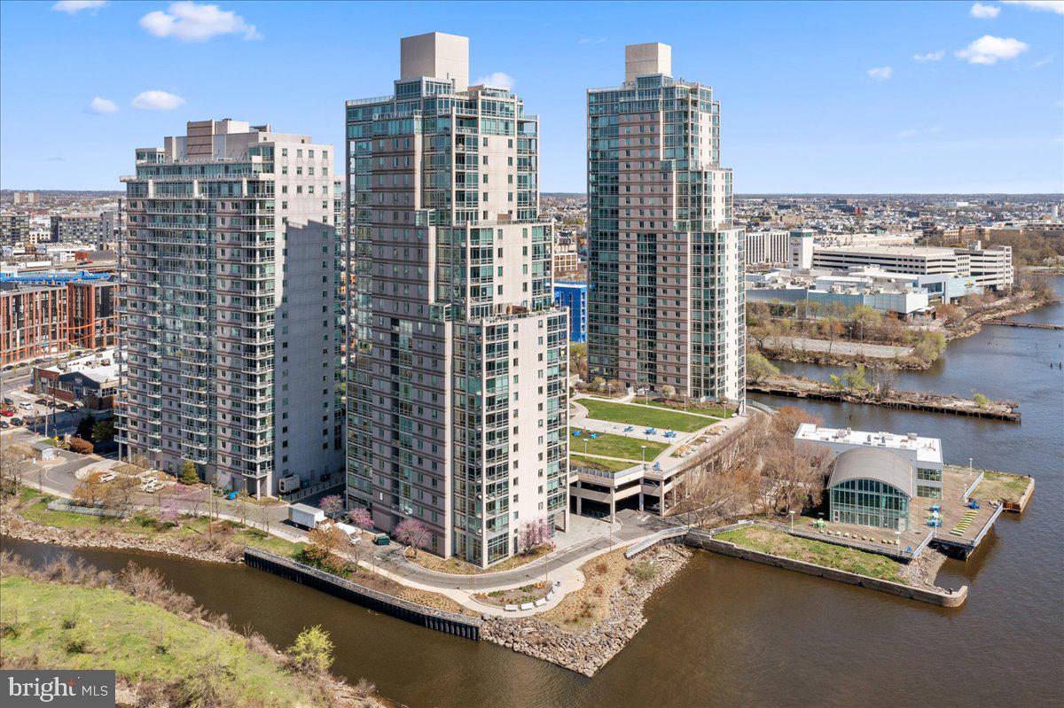 Luxury Waterfront Living at Its Finest! Welcome to 901 N Penn St Unit F803, a spacious and sun-soaked condo in the exclusive Waterfront Square community. This beautifully maintained 1-bedroom, 2-bathroom unit offers modern comfort, stunning views, and resort-style amenities—all in the heart of Philadelphia. Step inside to find a large, updated kitchen perfect for cooking and entertaining, flowing effortlessly into an expansive living room that opens to a private balcony overlooking the Delaware River and Ben Franklin Bridge—the perfect backdrop for morning coffee or evening wind-downs. The primary suite is your personal retreat, complete with a walk-in closet and an en-suite bathroom featuring both a soaking tub and a separate stand-up shower. The unit also includes a huge den ideal for a home office, guest space, or additional living area, plus a second full bathroom with a stand-up shower and an in-unit washer and dryer for ultimate convenience. Waterfront Square’s premier amenities include: 24/7 concierge & gated security, Private garage parking, Fitness center with sauna & steam room, Spa room with massage tables, Indoor pool with retractable doors for an outdoor feel, Hot tub, Dog park & children’s playground, Private walking trail & multiple outdoor spaces, Shuttle service to and from multiple locations throughout the city. Don’t miss your opportunity to live in one of Philadelphia’s most luxurious and amenity-rich communities. Schedule your private showing today and experience all that Waterfront Square has to offer!