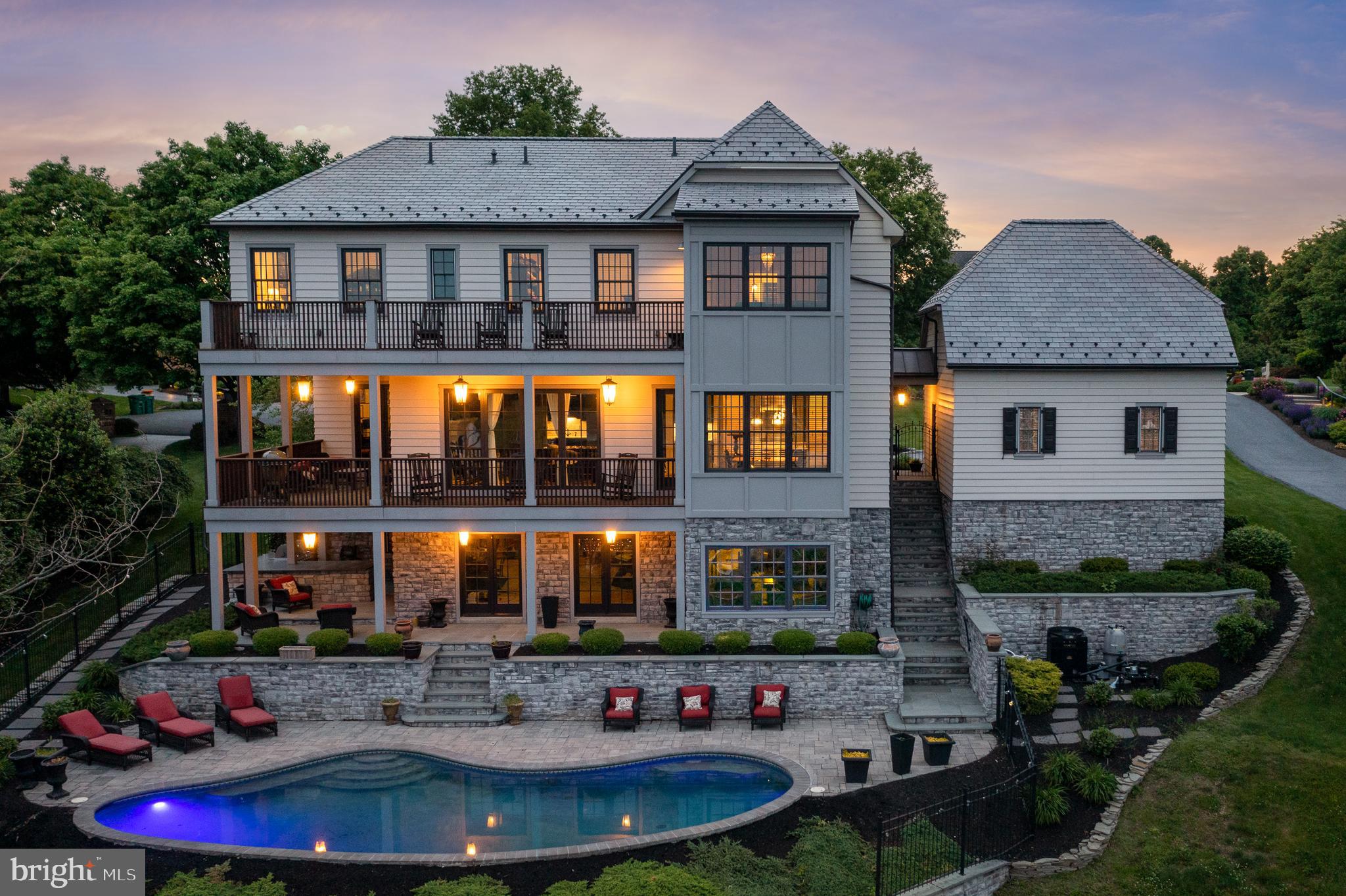 The finishes in this home are absolutely top of the line. As soon as you walk up to the front door, you will realize the Davinci composite roof, Hardy plank siding, and copper spouting and realize this home is something special. As you enter the front door, you will notice the 10’ high ceilings, custom milled 3/4 inch solid oak hardwood flooring which is throughout the home. The first floor features a large kitchen with a huge island and eating area with top of the line appliances. The family room has a gorgeous fireplace with built-ins, a wet bar and also has lanai doors that fully open to the balcony overlooking the backyard and pool area. The first floor also has a large dining room, great for entertaining and a bedroom/office with a private full bath. The upper level has 9’ ceilings and features a 2nd floor laundry room and 4 bedrooms including a HUGE owners suite with large closets and a beautiful bath with a tile shower, large soaking tub and  cathedral ceiling. There is also a large balcony off the owners suite with views for miles. The walkout basement which is ready to be finished leads out to the  backyard area which features an in ground Sylvan pool, beautiful landscaping and an outdoor kitchen area.