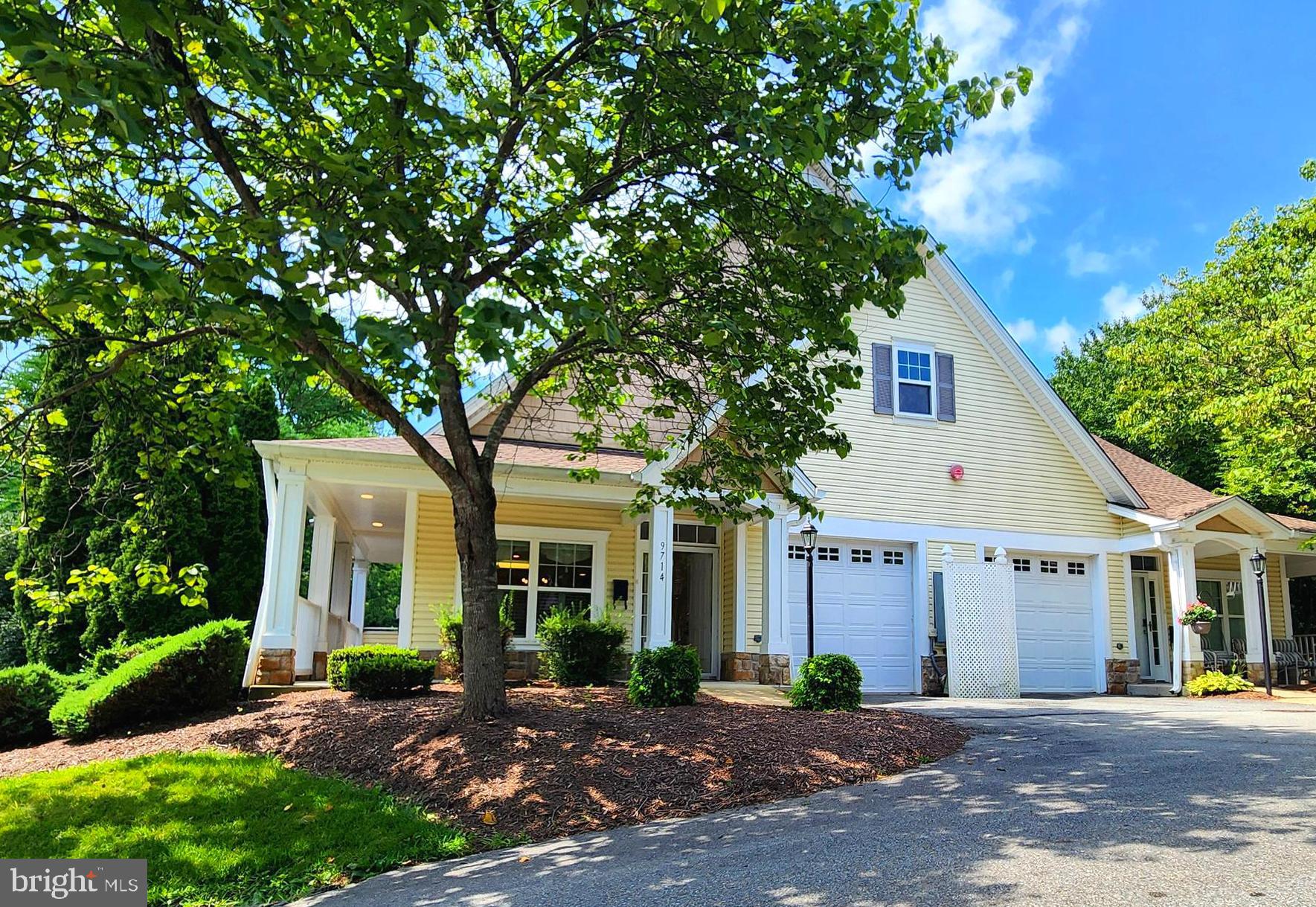 This lovely 62+ community of Meadow Ridge (one resident must be 62+) features attractive architecture, convenient location and beautiful surroundings. The condo offers single level living with an open floorplan, 9' high ceilings and two spacious bedrooms both with attached baths and plenty of closet space.  The kitchen features granite countertops, updated appliances and a large island that's perfect for entertaining guests. Ground level entry with no units above. Relaxing, covered front porch and side balcony are perfect for enjoying the outdoors. Finished attached garage, private driveway and guest parking available. Virtual staging used on some images.