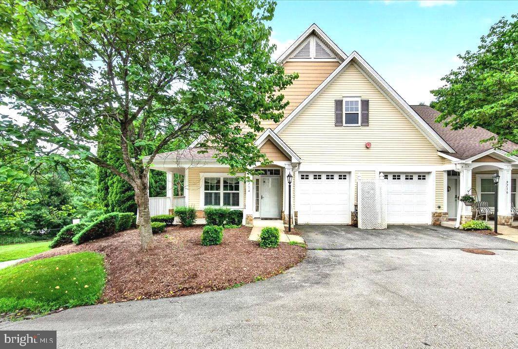 This lovely 62+ community features attractive architecture, convenient location and beautiful surroundings. The condo offers single level living with an open floorplan, high ceilings and two spacious bedrooms both with attached baths and plenty of closet space.  The kitchen features granite countertops, updated appliances and a large island that's perfect for entertaining guests. Ground level entry with no units above. Relaxing, covered front porch and side balcony are perfect for enjoying the outdoors. Finished attached garage, private driveway and guest parking available. Virtual staging used on some images.