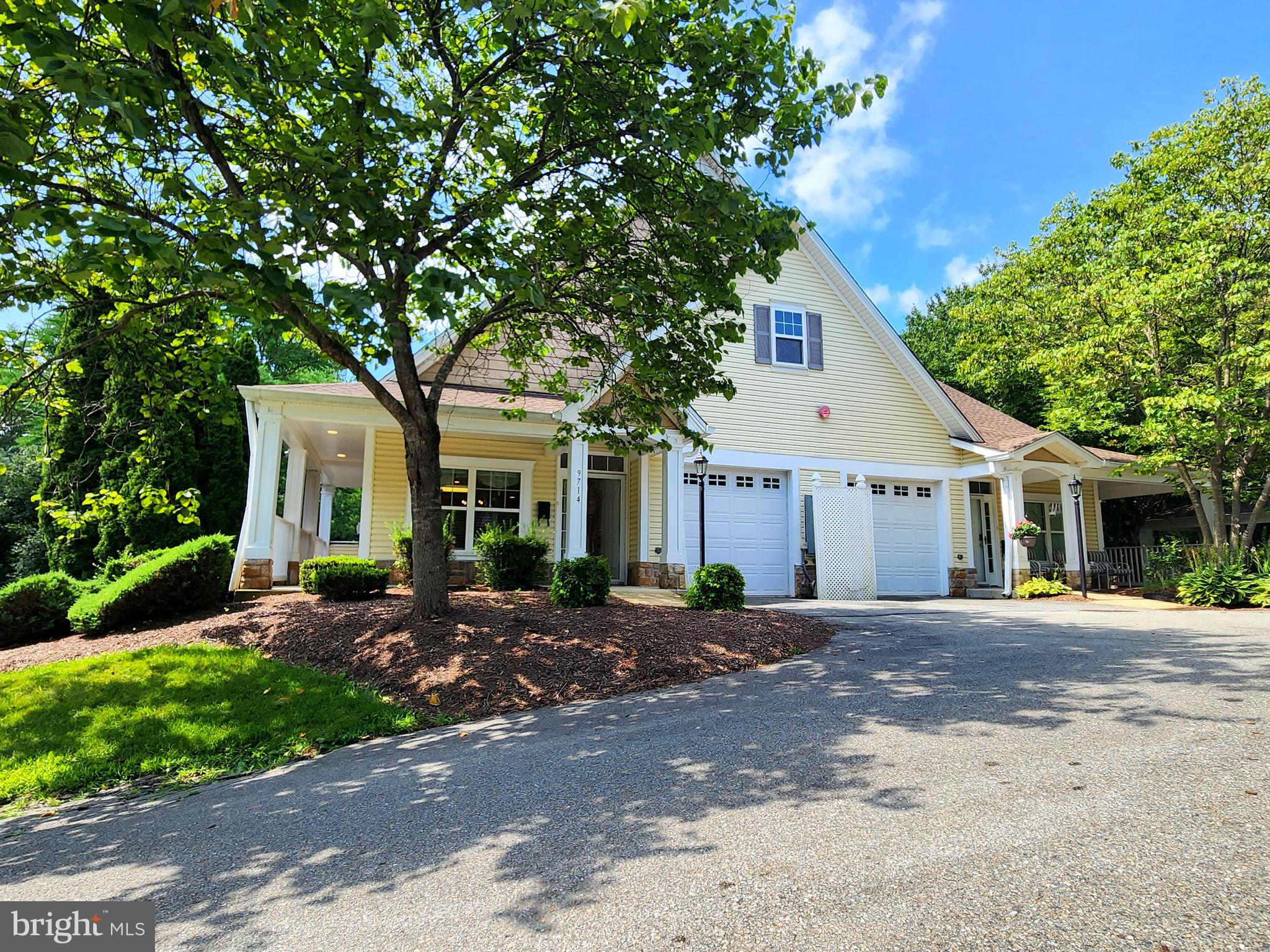 This lovely 62+ community of Meadow Ridge (one resident must be 62+) features attractive architecture, convenient location and beautiful surroundings. The condo offers single level living with an open floorplan, 9' high ceilings and two spacious bedrooms both with attached baths and plenty of closet space.  The kitchen features granite countertops, updated appliances and a large island that's perfect for entertaining guests. Ground level entry with no units above. Relaxing, covered front porch and side balcony are perfect for enjoying the outdoors. Finished attached garage, private driveway and guest parking available. Virtual staging used on some images.