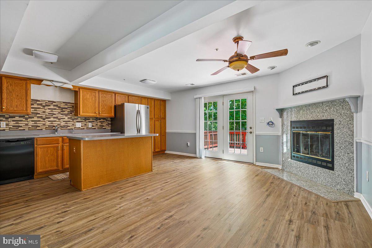 AMAZING TOWNHOME WITH A FULL BATH  IN THE WALK-OUT BASEMENT PLUS GARAGE!   Come and see - you won't be disappointed!   This beautiful brick townhome with 3 finished levels has plenty of natural light and in a community full of amenities plus  a great location.  You will find 3 spacious bedrooms on the second level with 2 full bathrooms.  The main level has your living room, dining area, fireplace, a beautiful kitchen with stainless steel appliances, a half bath and, for your enjoyment, access to a very nice deck. Refrigerator to be replaced.   Also, there is a finished and large walk-out basement  with a full bathroom.   From the basement you can go out and enjoy a nice backyard.  And, to top it off, you have a spacious attached garage and driveway.  This community has many amenities to offer - like a swimming pool, tennis courts, tot lots/playground, club house and more.  Don't let this one pass you by!