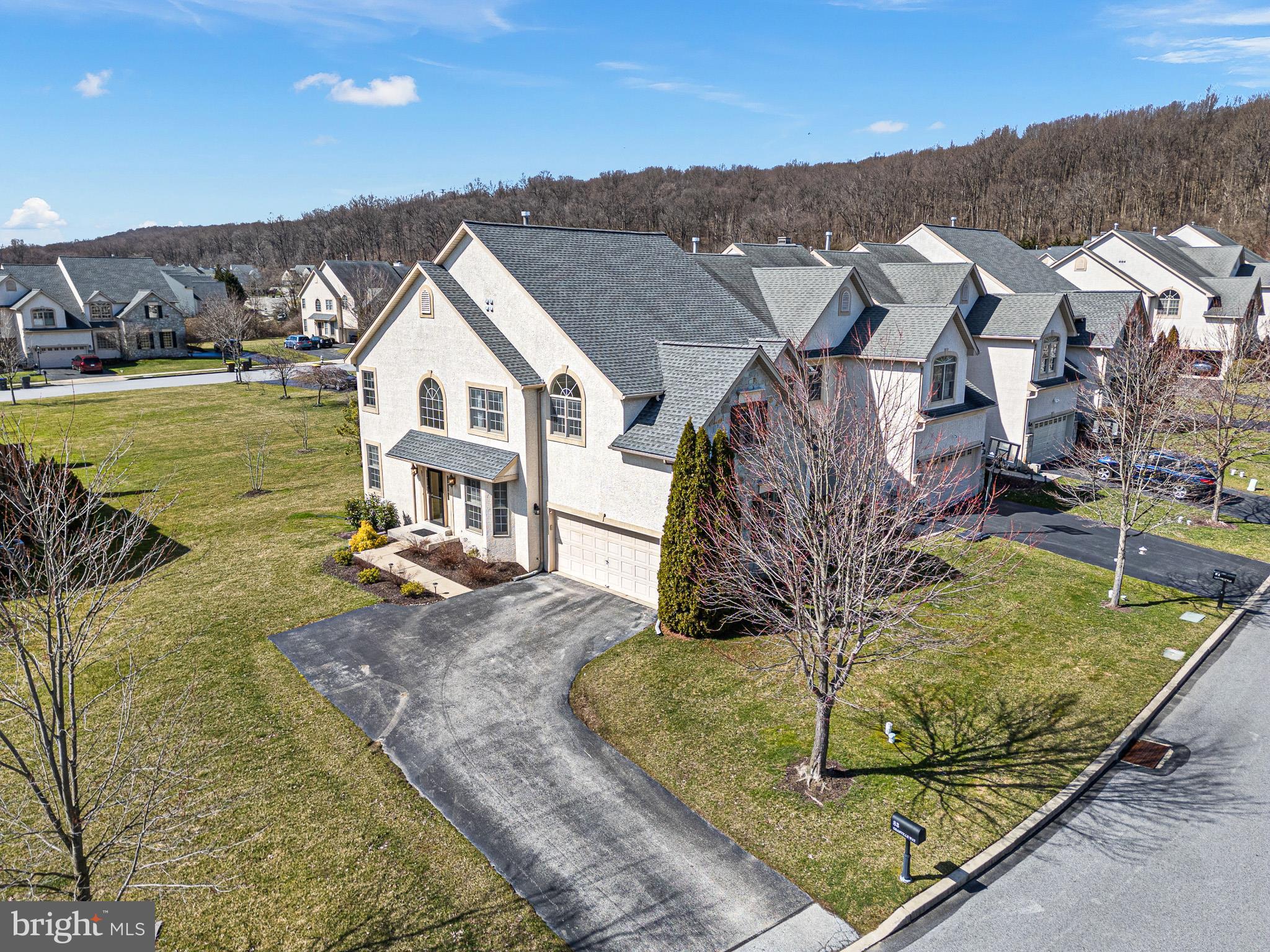 It's hard to find this quality of a home, moreover square footage (+3500)  so close to all of the amenities: minutes to Exton Station, premiere shopping, and community parks and recreation. Highly acclaimed and coveted Great Valley Schools are the icing on the cake!   A beautiful and elegant turned staircase sets the tone upon entering this spacious and well-appointed end-unit carriage home. The center hall Entry is flanked by a Living Room, perfect for a Home Office or Study, and a Dining Room with handsome bay window.  The heart of the home is the magnificent 2-story Great Room and open Kitchen. A gas fireplace with traditional hearth and mantle, and a wall of windows adorn the home's focal wall, allowing an abundance of light to flow throughout this grand 2-story living space. It's here you'll find 2 patio doors to the back deck overlooking the large rear and side yard.  The well-appointed Kitchen features 42-inch cherry cabinets, center island, double wall oven, gas cooktop and side-by-side refrigerator.  Make the space off the Kitchen into a cozy and casual Sitting Room or additional eat-in Dining nook.  The lower level is the entire footprint of the home, most of which is finished, making space for a wonderful Play Room, Recreation Room and private Home Office (glass pocket doors).  The spacious second floor Owner's Suite is a marvelous retreat!  Here you'll find a pleasing vaulted ceiling, his and hers walk-in closets, and a cozy Sitting Room perfect for a good book and cup of tea, or your morning yoga.  The Owner's Suite Bath features an extra deep Japanese soaking tub. There are two (2) 75-gallon hot water tanks so you'll never have to worry about running out of hot water.  83 Granville Way is a spacious end-unit carriage home (over 3500 square feet) that lives like a single family home with 2-car garage, ample parking and an oversized yard.  Full lawn maintenance is handled by the HOA.  Recent improvements include new roof (2016), new HVAC (2017) and new 75-gal hot water tank (2018). There is a medical grade KD whole home water filtration system.  Home is being marketed and sold as is.