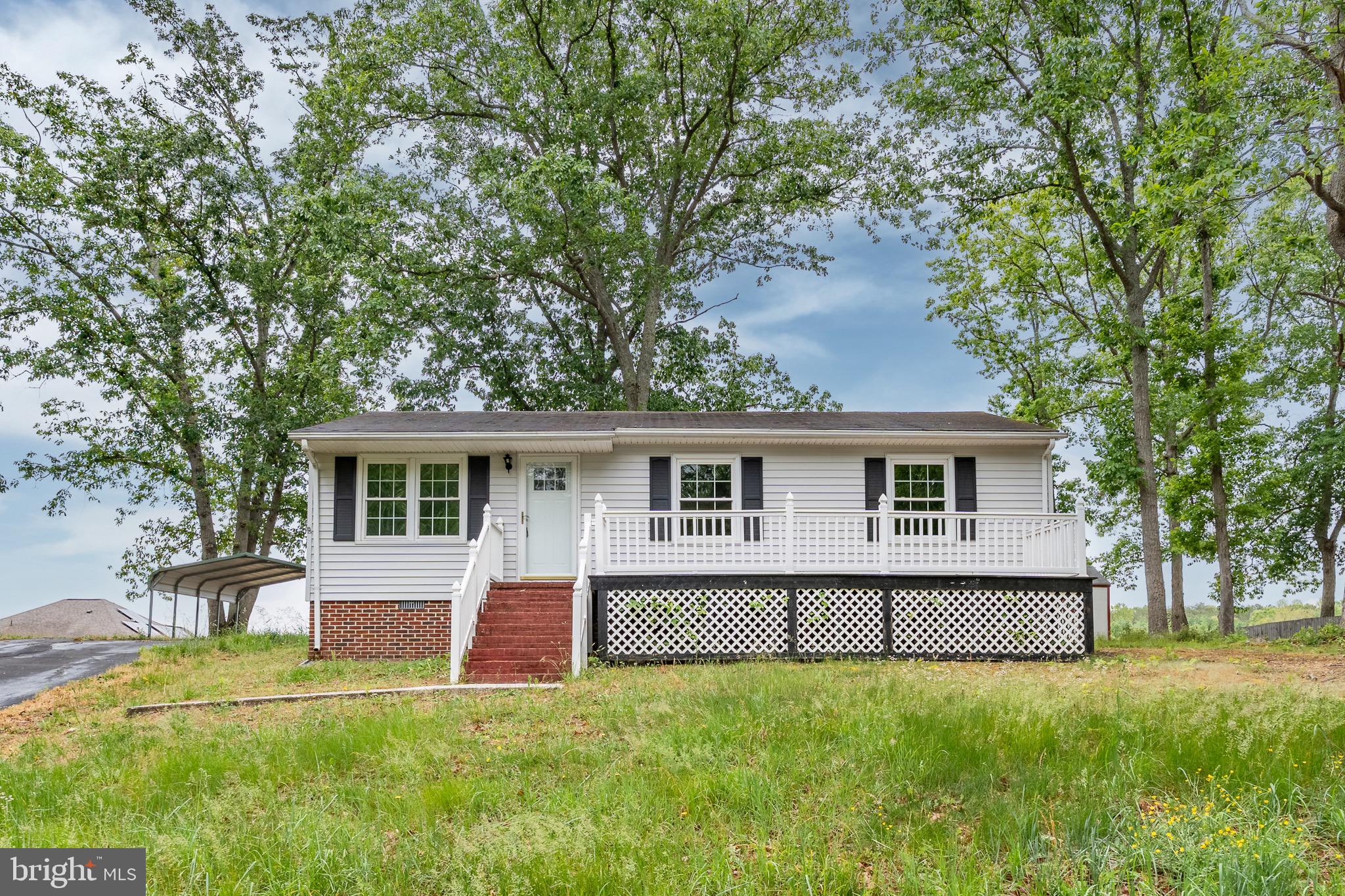 This charming ranch-style home offers the kind of easy, comfortable living that just feels right from the moment you pull in. A spacious covered front porch welcomes you home and creates the perfect spot for morning coffee, porch swings, or winding down at the end of the day. Inside, the kitchen is designed to be the heart of the home with generous countertop space, a center island for gathering, sleek range hood, and stainless steel appliances that give the space a clean modern touch.
The layout flows comfortably with hardwood flooring throughout the main living areas, cozy carpet in the bedrooms, and a tiled full bath complete with a tub/shower combo. A washer and dryer hookup conveniently located just off the kitchen adds everyday practicality without sacrificing space.
Outside, you'll appreciate the large paved driveway, attached carport for covered parking, and two storage sheds offering plenty of room for tools, hobbies, lawn equipment, or extra storage. Whether you're looking for your first home, downsizing, or simply searching for something with charm and functionality, this home has a warm and welcoming feel that’s easy to love.